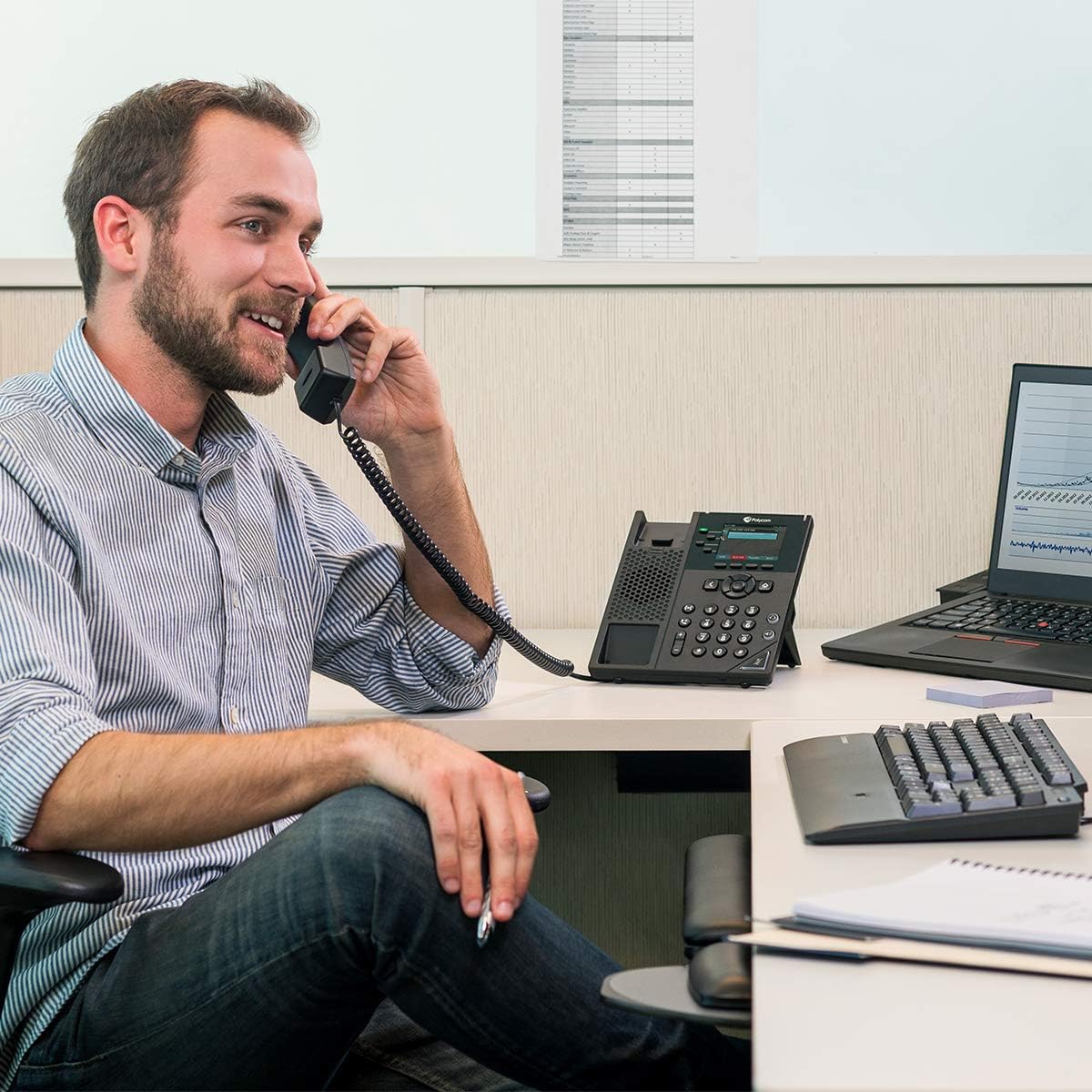 Person using Polycom VVX 250 IP Desk Phone in an office setting.