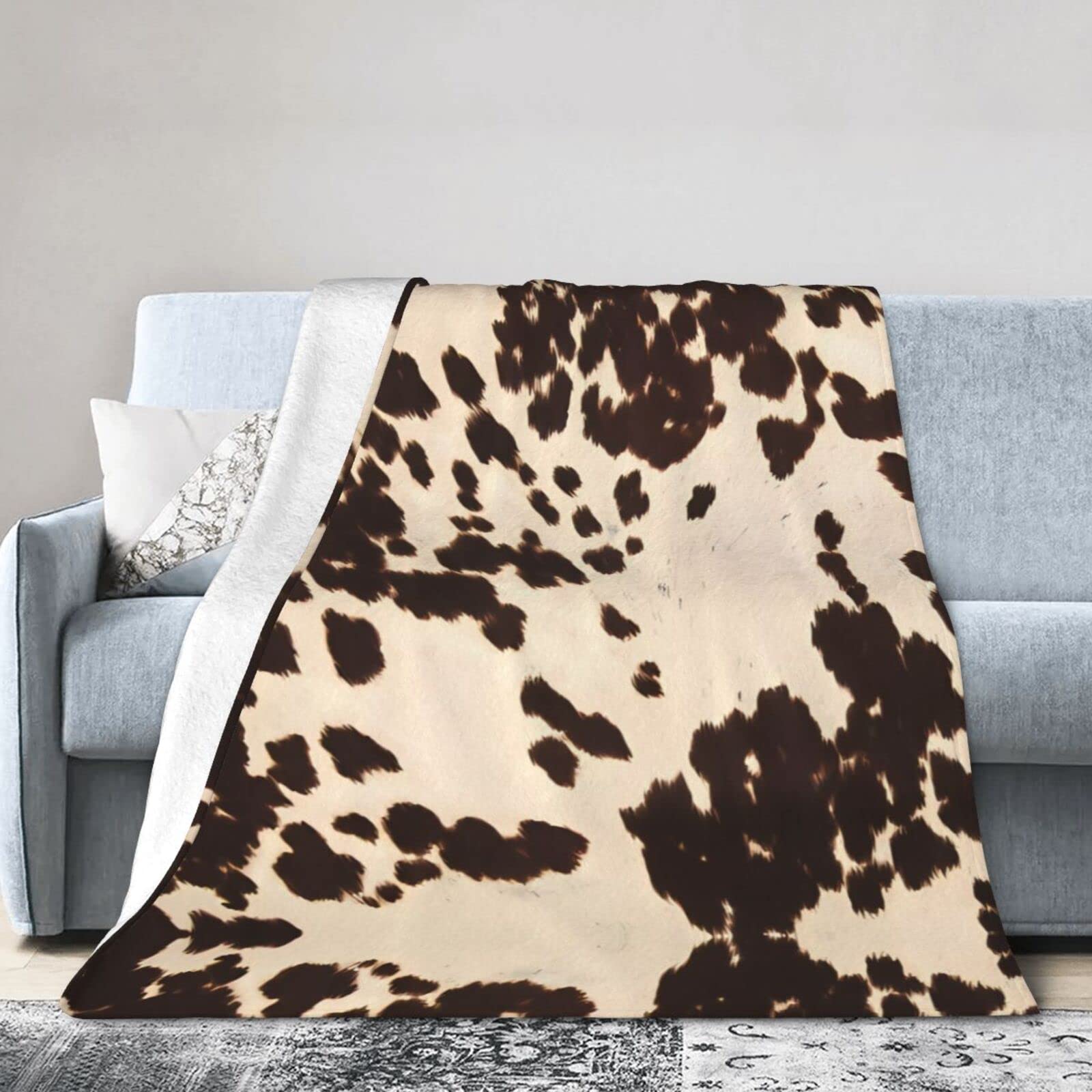 Couverture en micro polaire motif cuir de vache pour soirées canapé chaleureuses