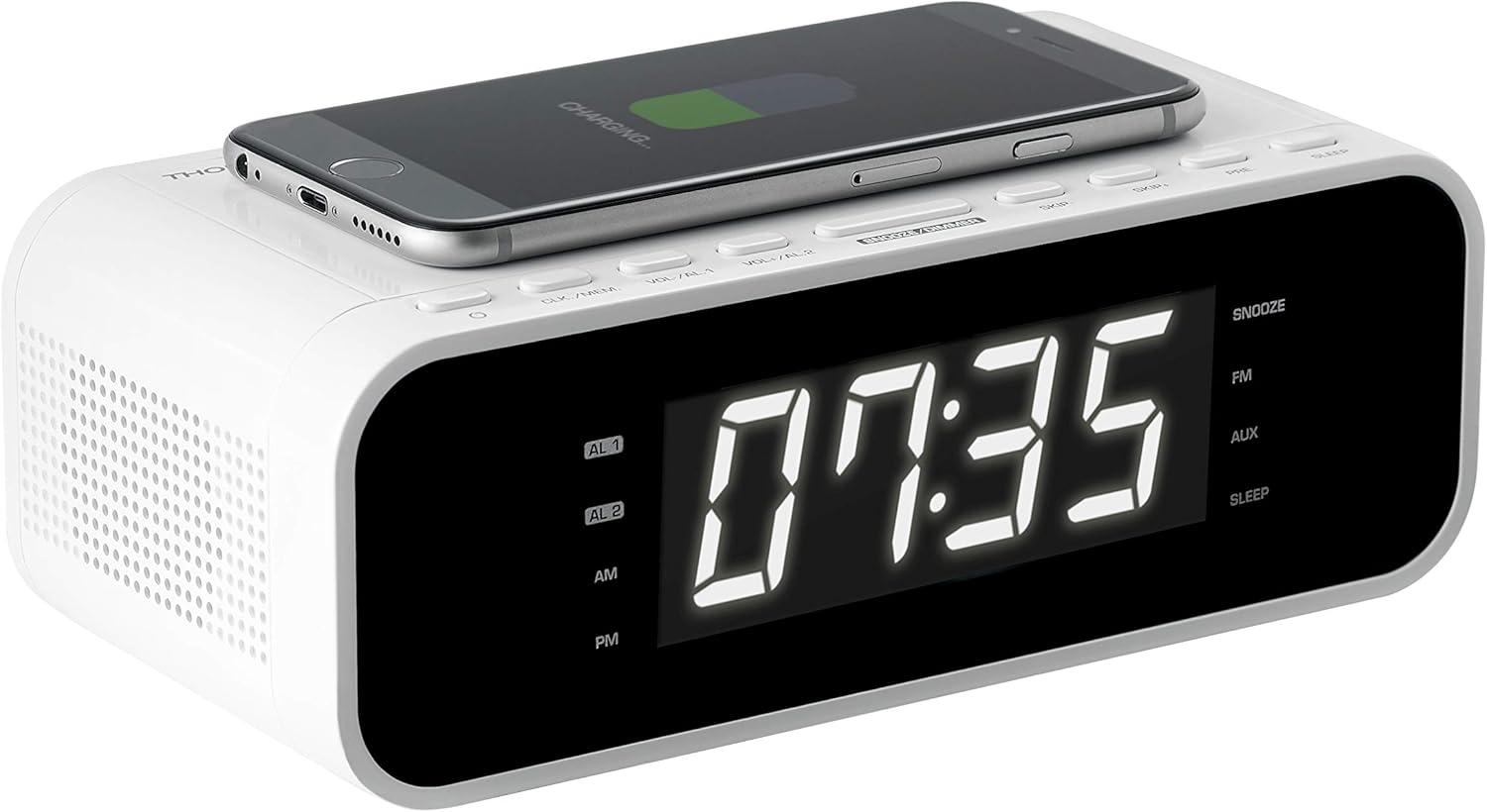 Angled view of the Thomson CR221I with a smartphone placed on the wireless charging pad, showing the charging indicator on the phone screen.