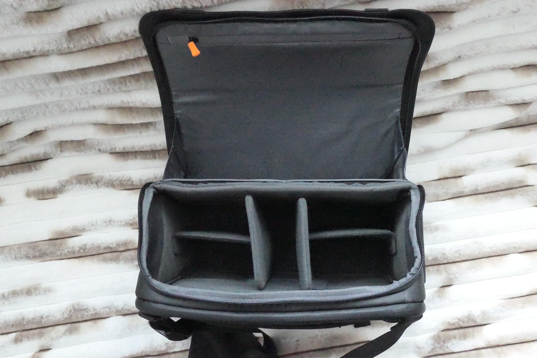 Decent mid-sized photographer's sling bag, good size to capacity ratio, quality materials