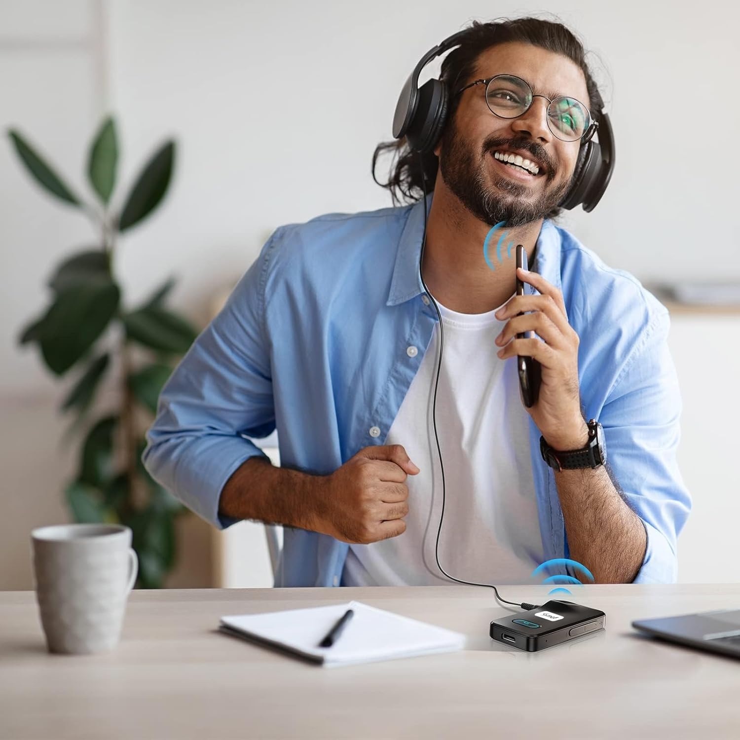 Person using the Smof Bluetooth adapter with wired headphones