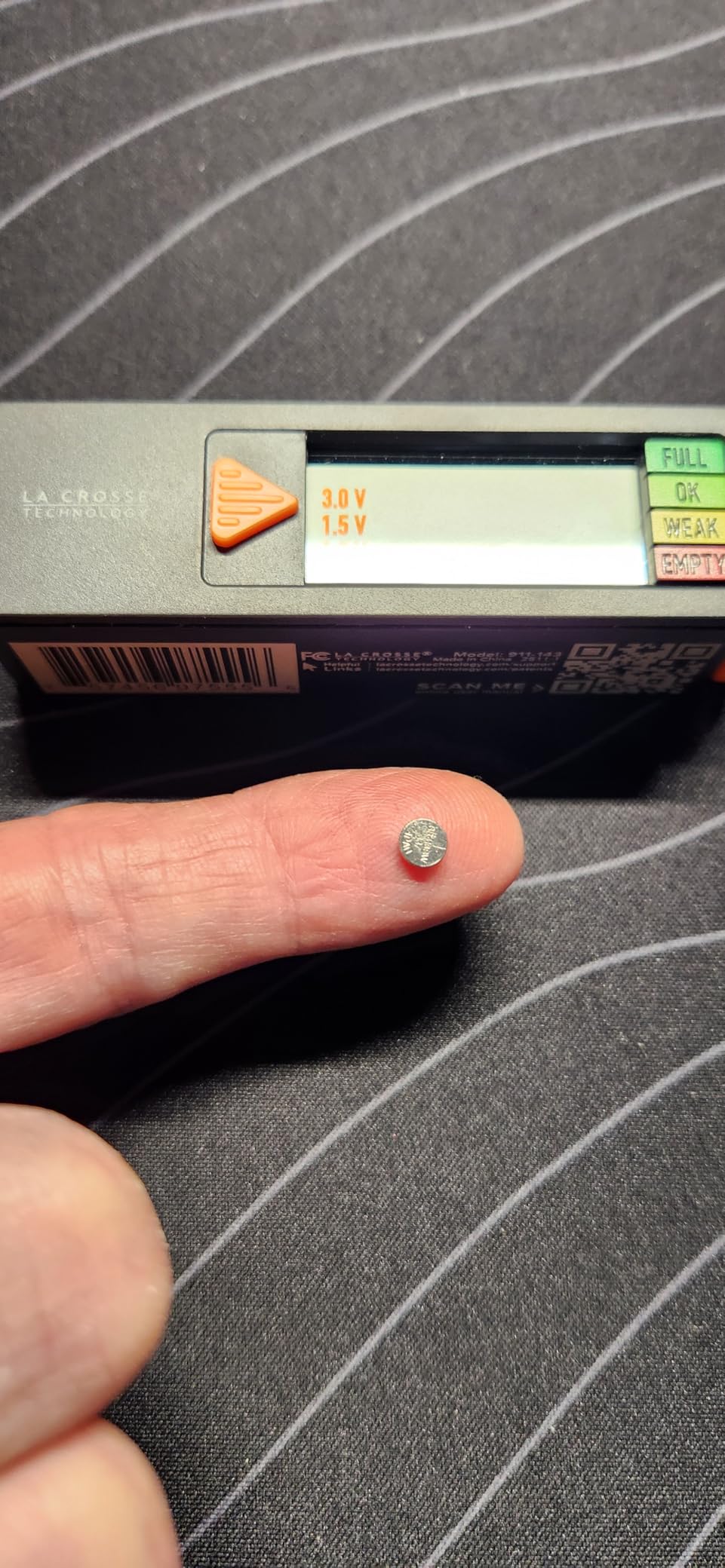 Testing a small button battery with the La Crosse tester