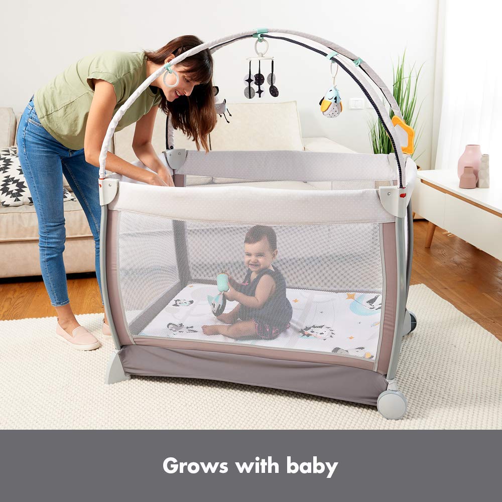 Image showing the removable changer attached to the playard with a baby on it and storage organizer on the side.