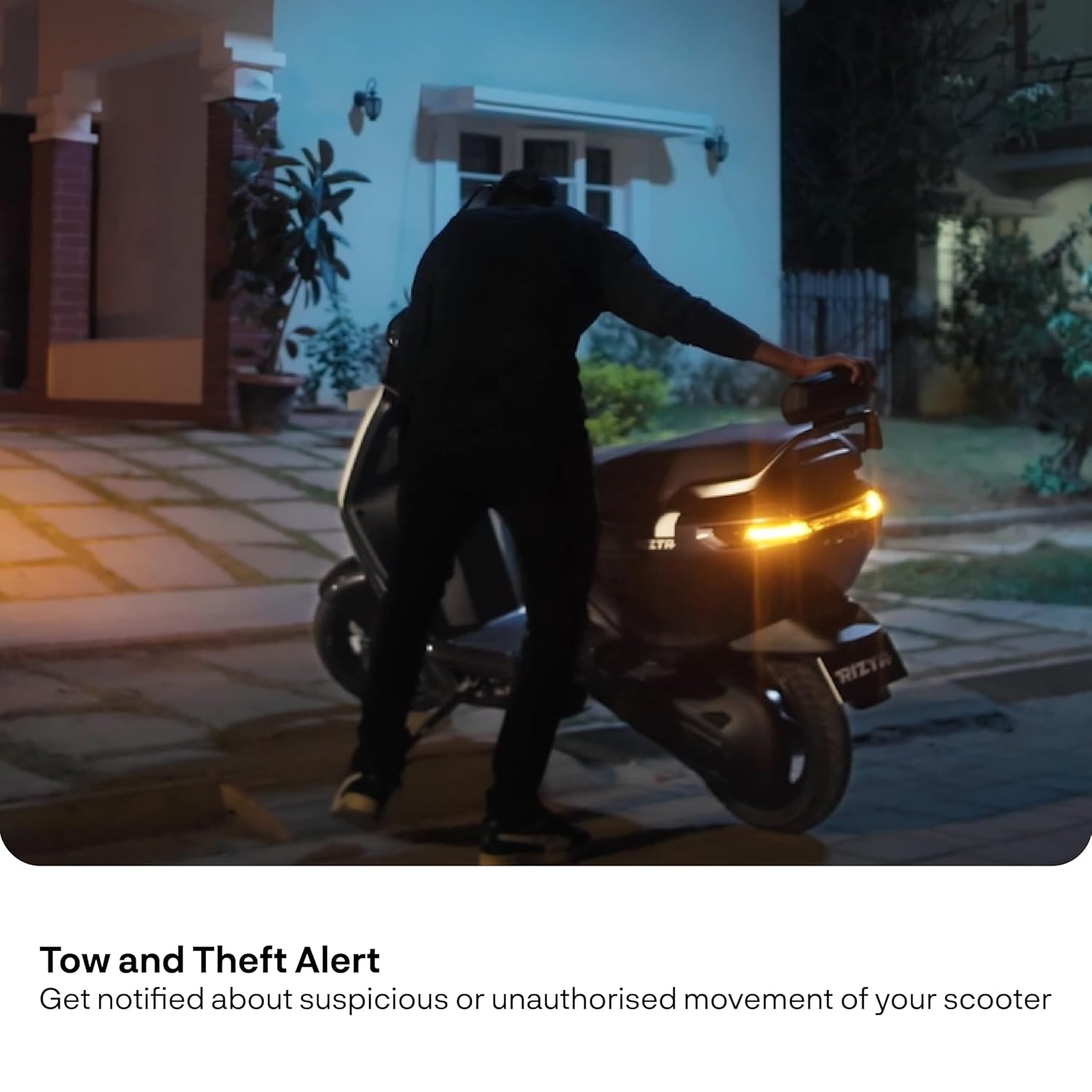 Person attempting to move a parked Ather Rizta Z, triggering a theft alert