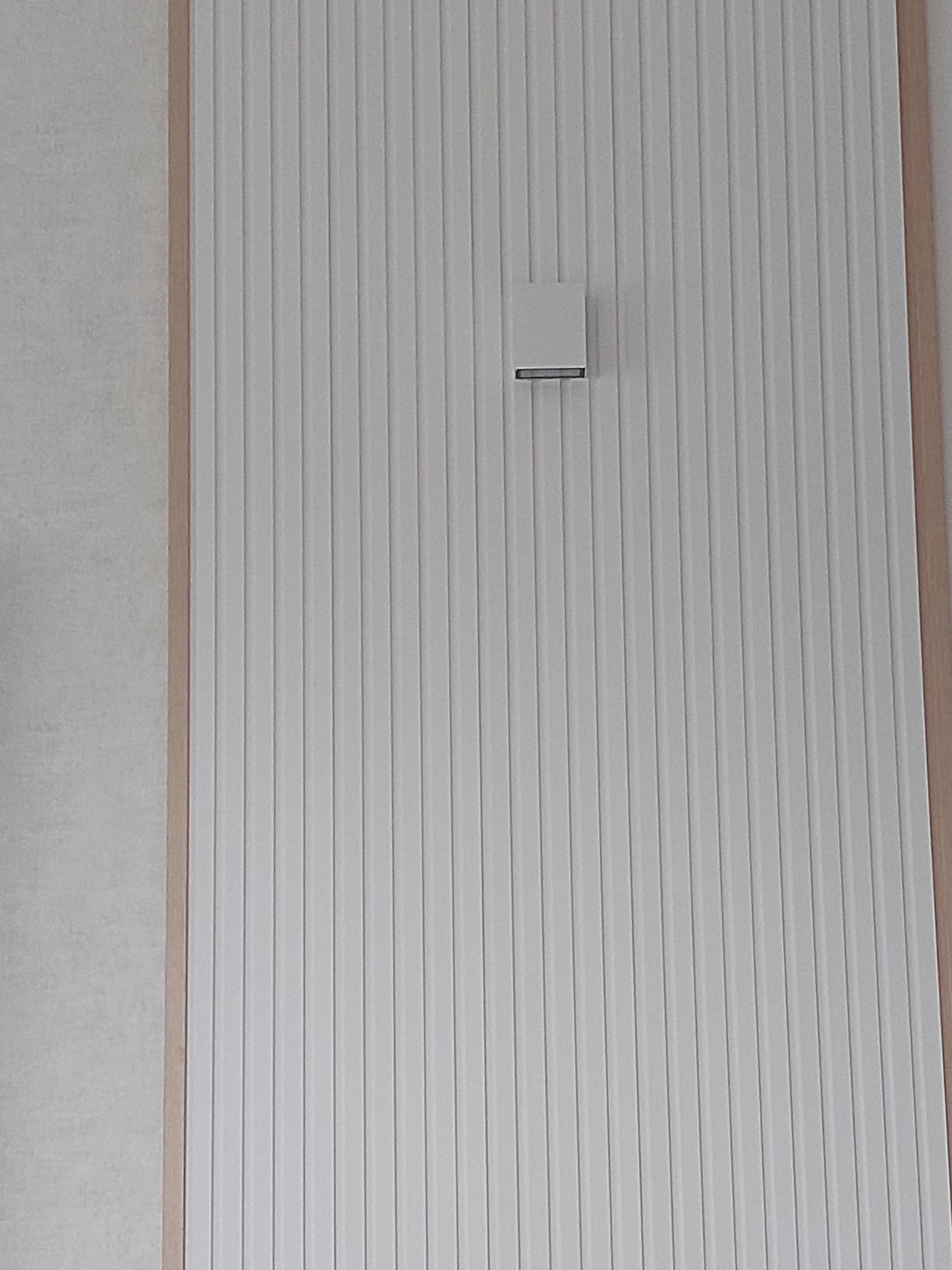 Klighten 7W LED Wall Light installed on a brick wall next to a house number.