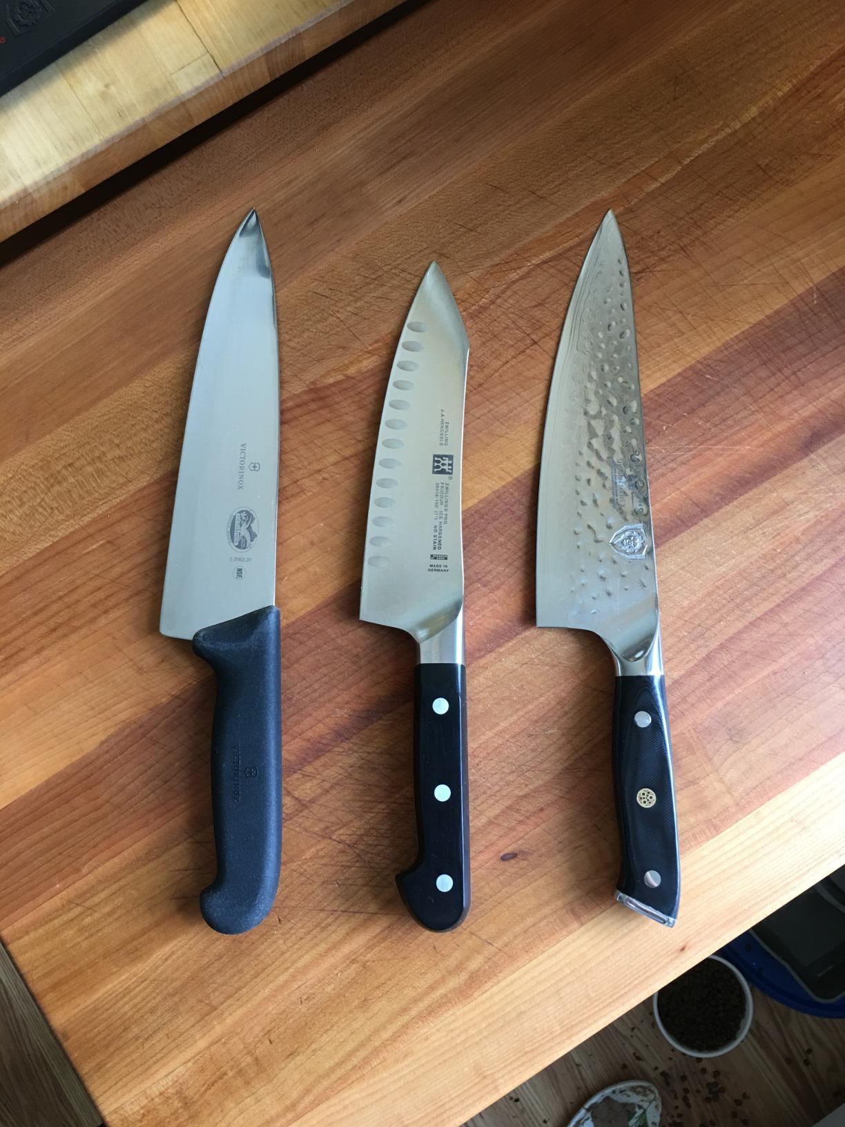 Best Damascus steel knife with layered pattern blade on wooden cutting board