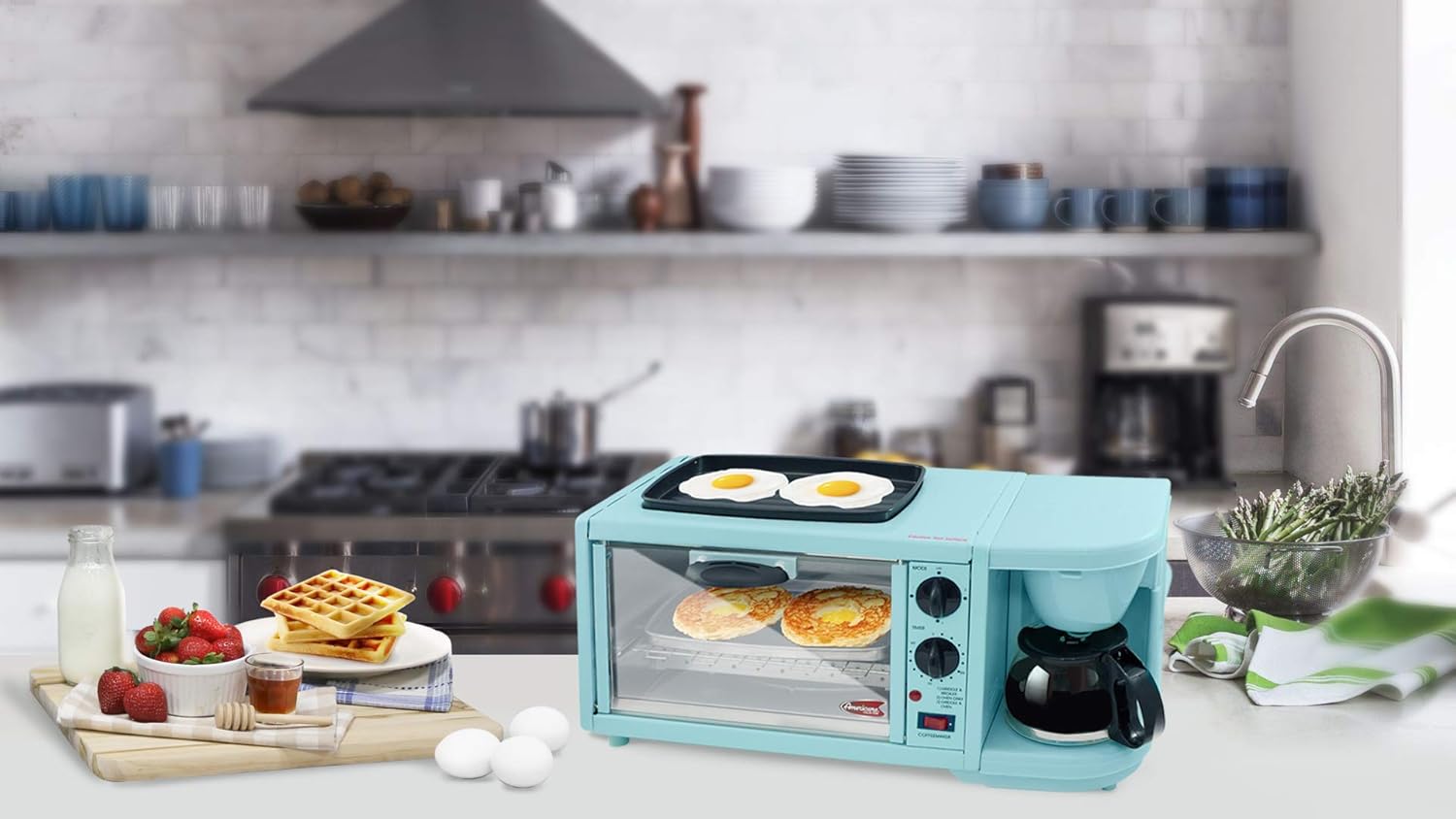 A complete breakfast spread with eggs on the griddle, waffles in the oven, and fresh fruit