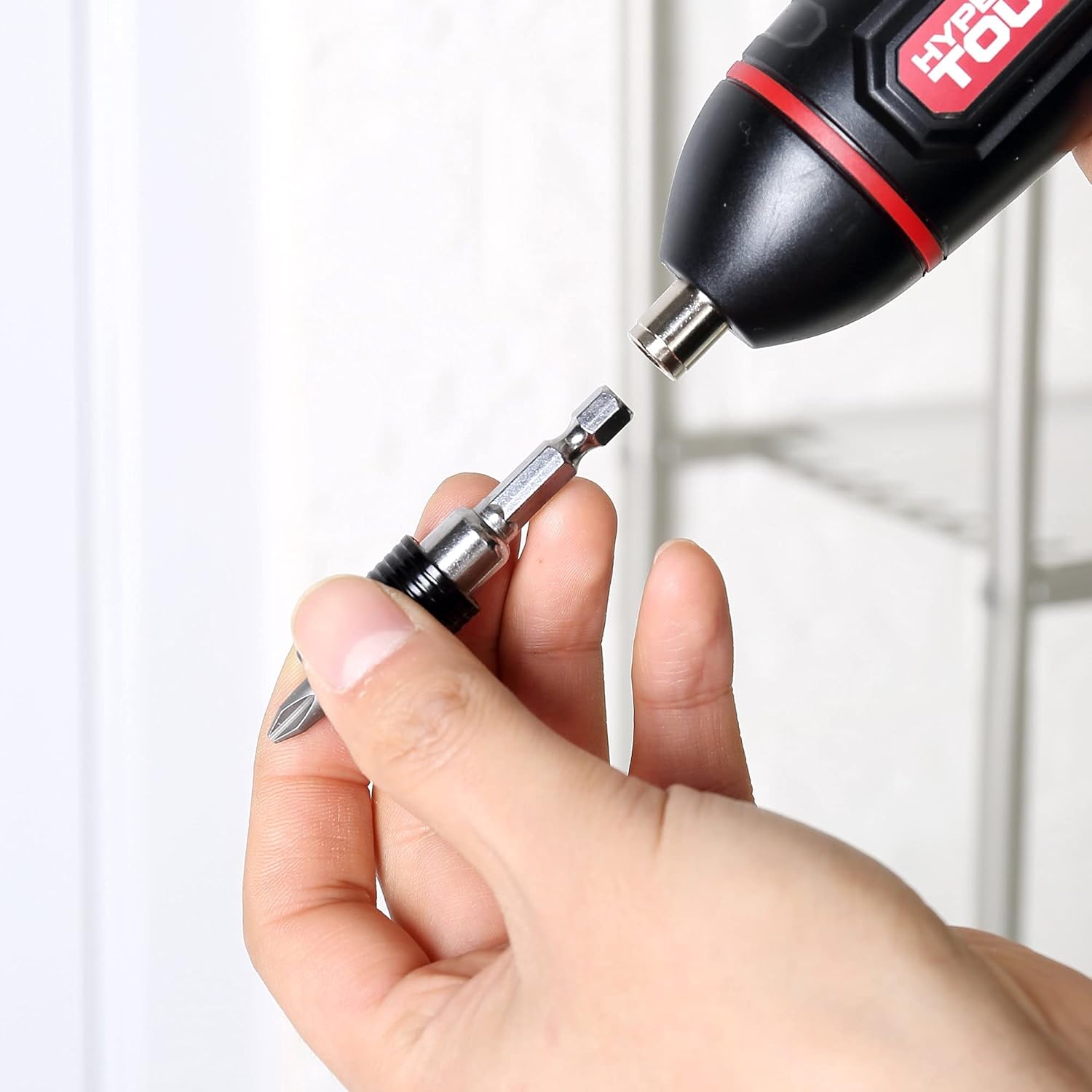 Person using a drill with the Hyper Tough bit set to drive a screw