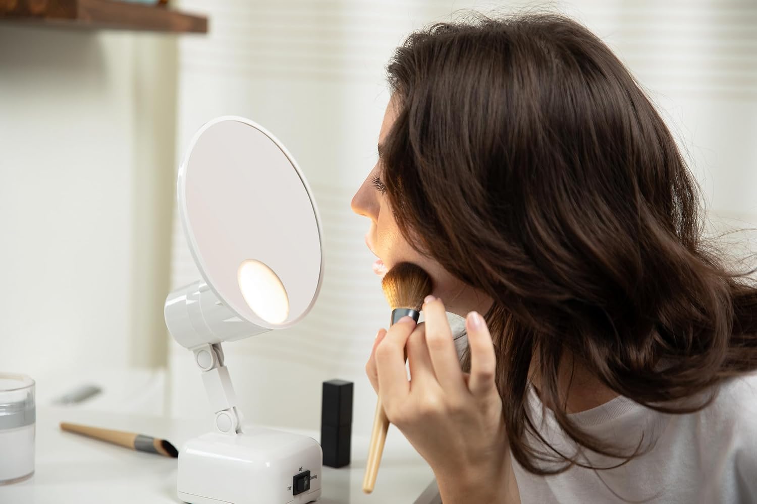 A person using the Floxite FL-615-2 mirror for makeup application