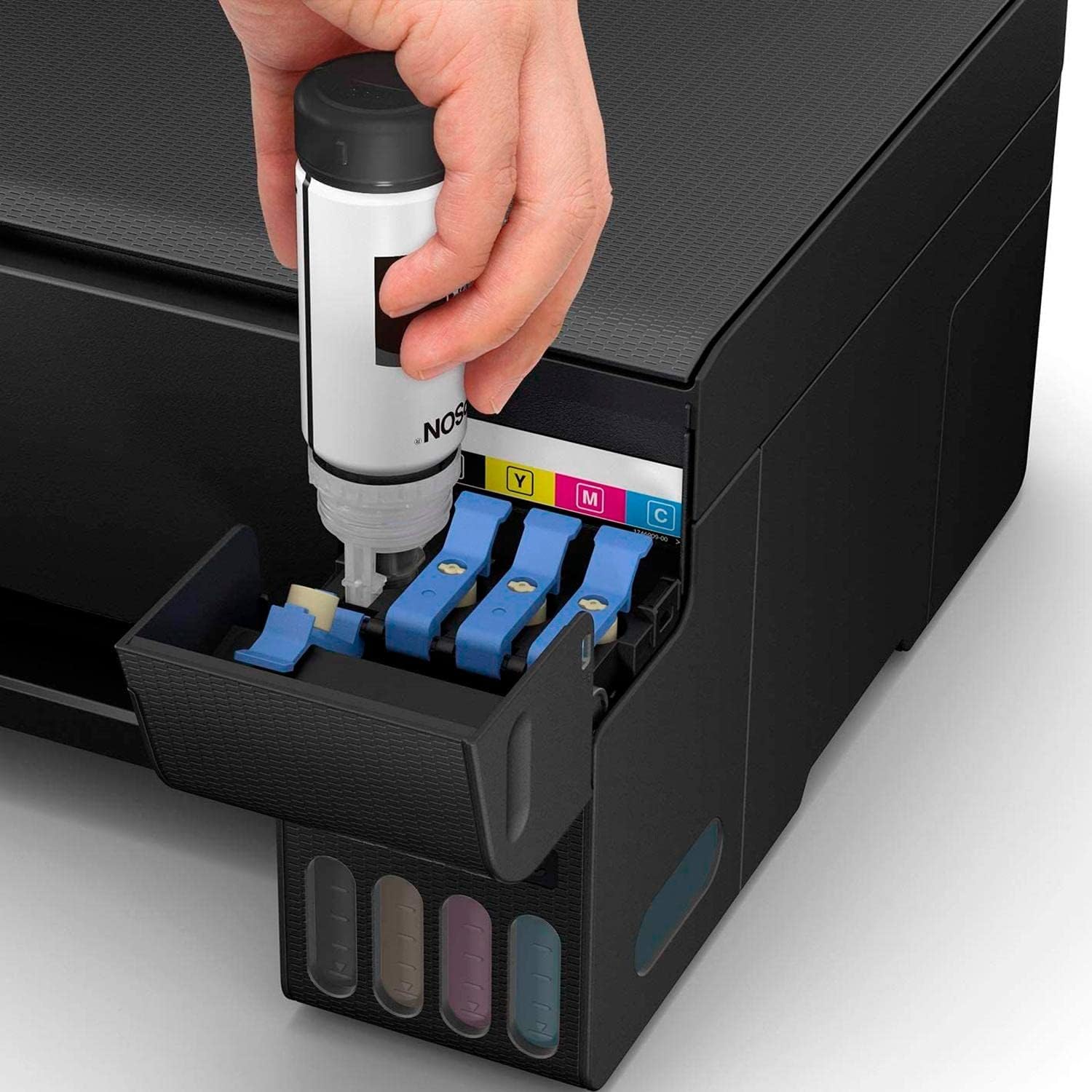 A hand pouring black ink from an Epson ink bottle into the black ink tank of the Epson EcoTank L3150 printer.