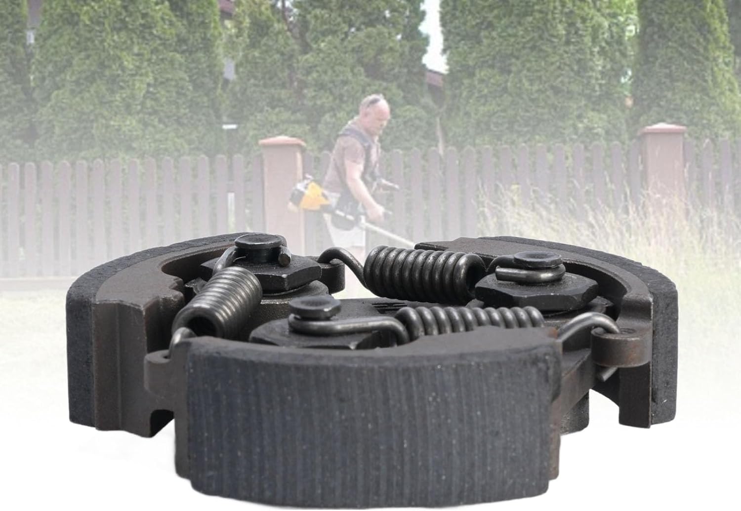 Image showing the coupling in the foreground with a person operating a brush cutter in the background