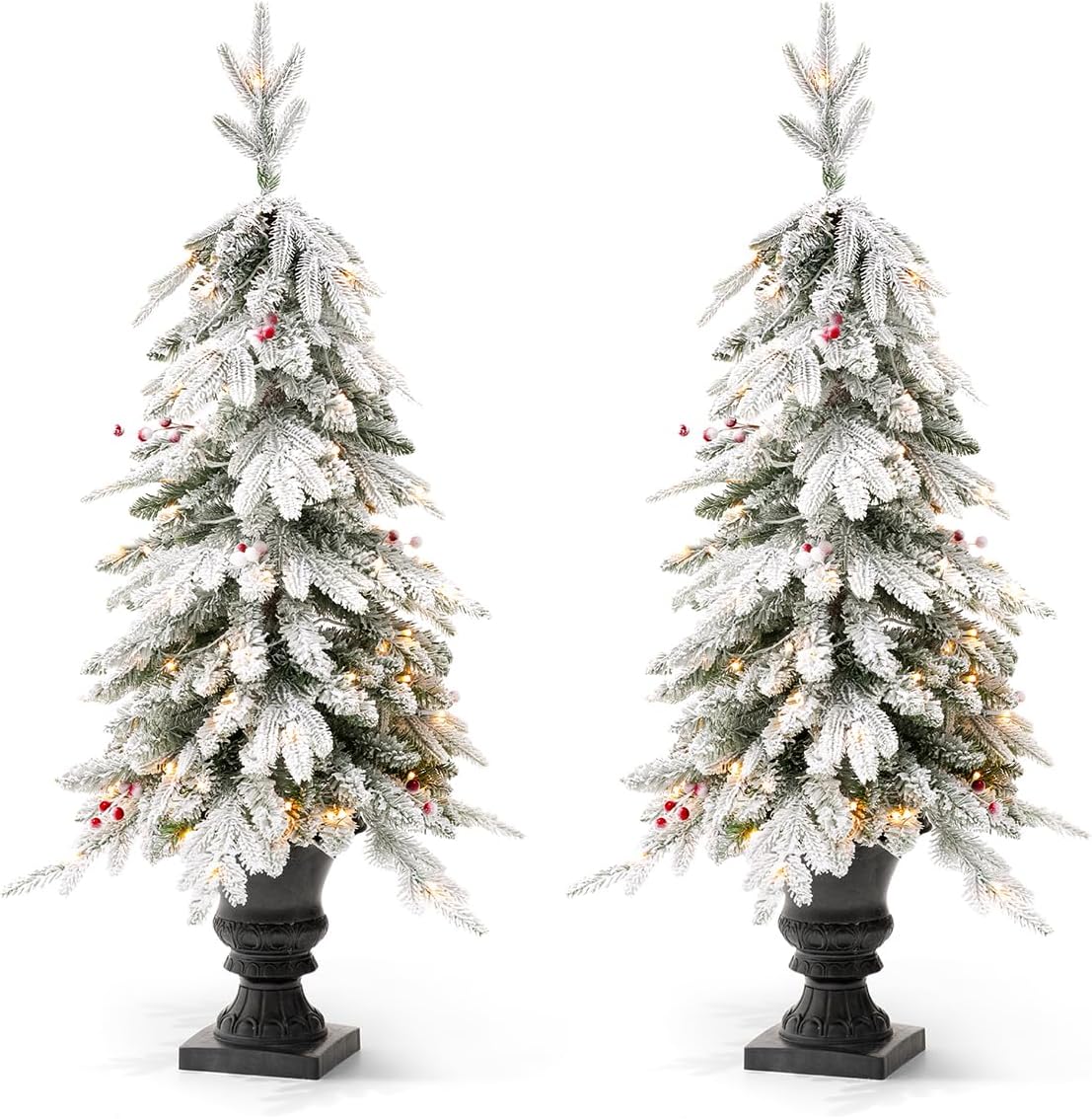 Two Glitzhome 4ft flocked Christmas trees with warm white lights and red berries, in urn bases, shown against a white background.