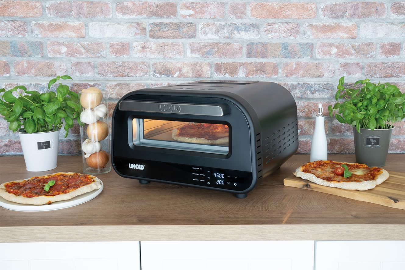 Unold Pizza Oven on a kitchen counter with two freshly baked pizzas