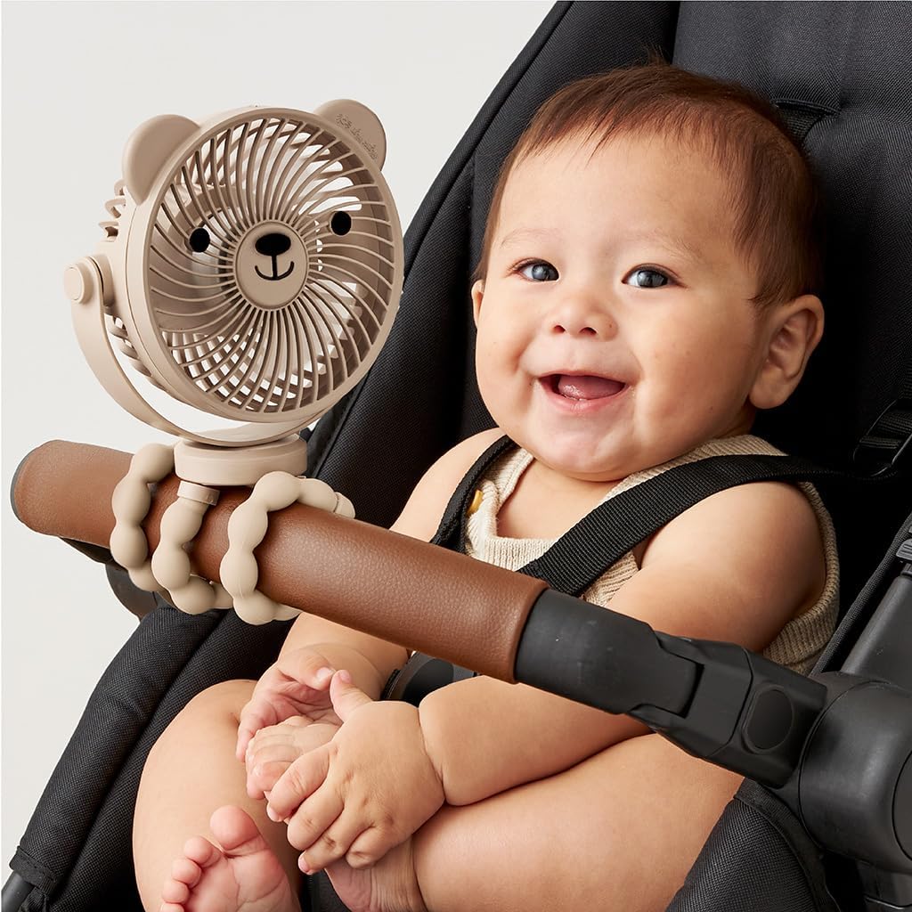 Baby in stroller with Itzy Ritzy Stroller Fan attached to the stroller bar