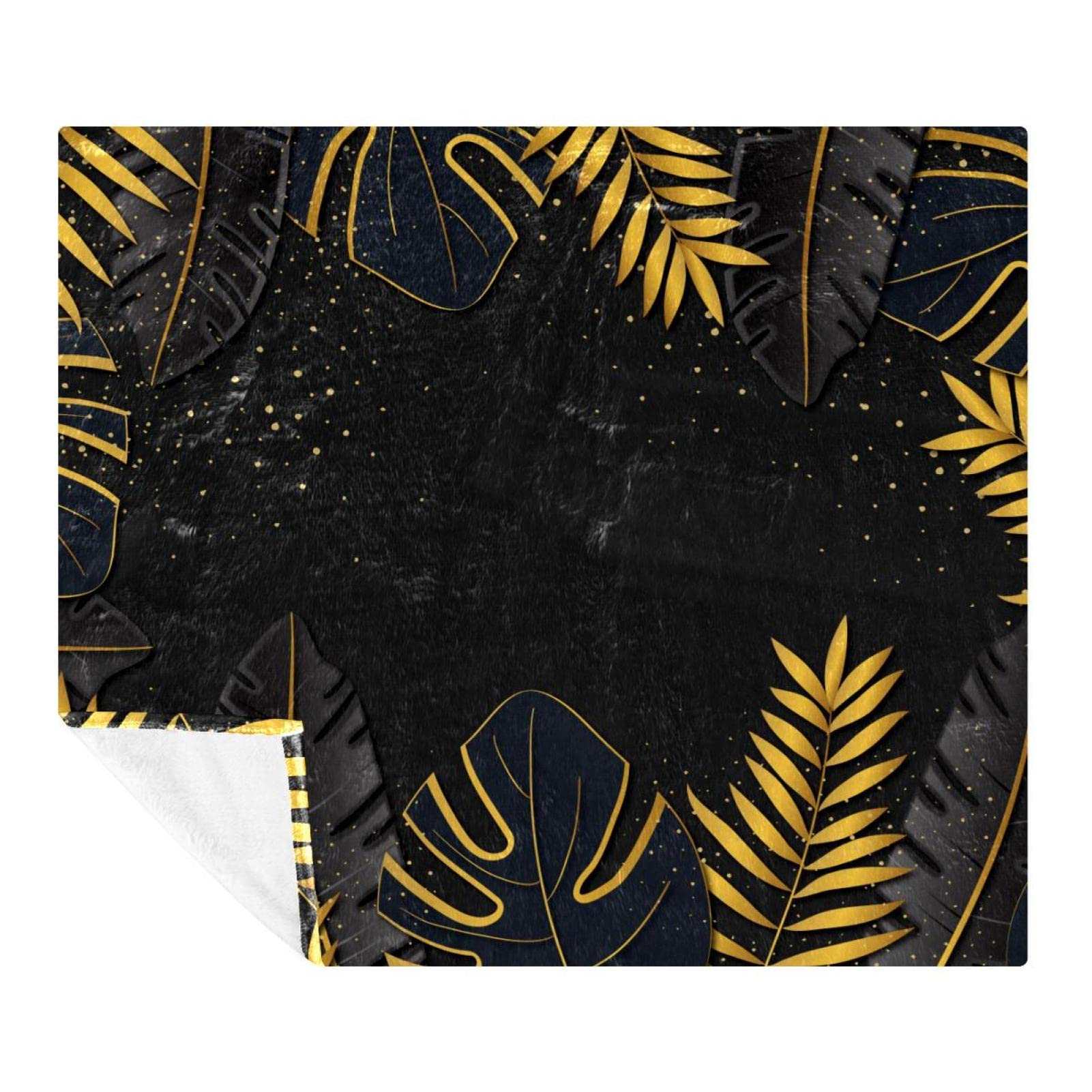 Couverture polaire douce feuilles d'or tropicales pour un intérieur cosy