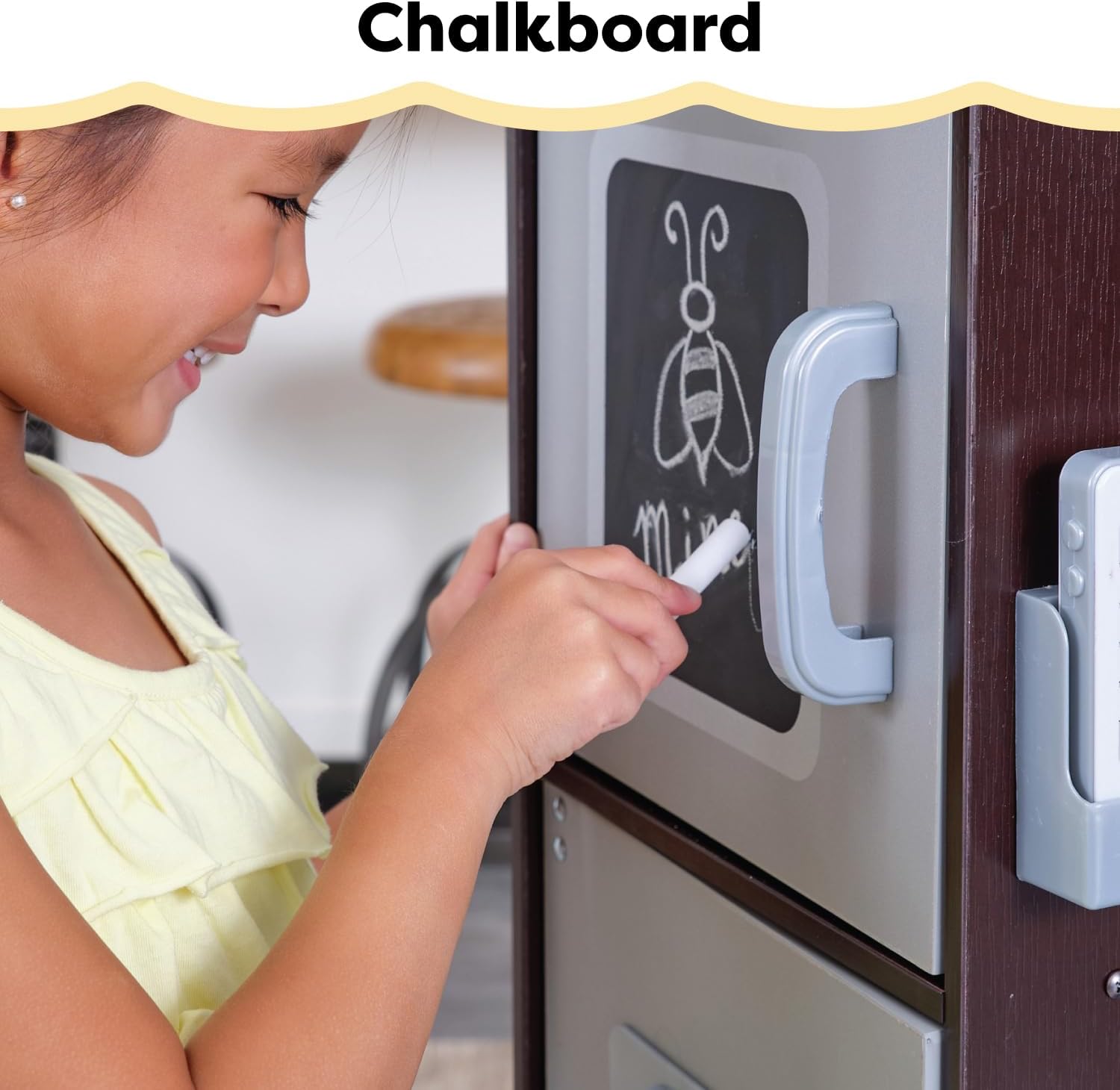 Hand turning a click-and-turn knob on the play kitchen stove