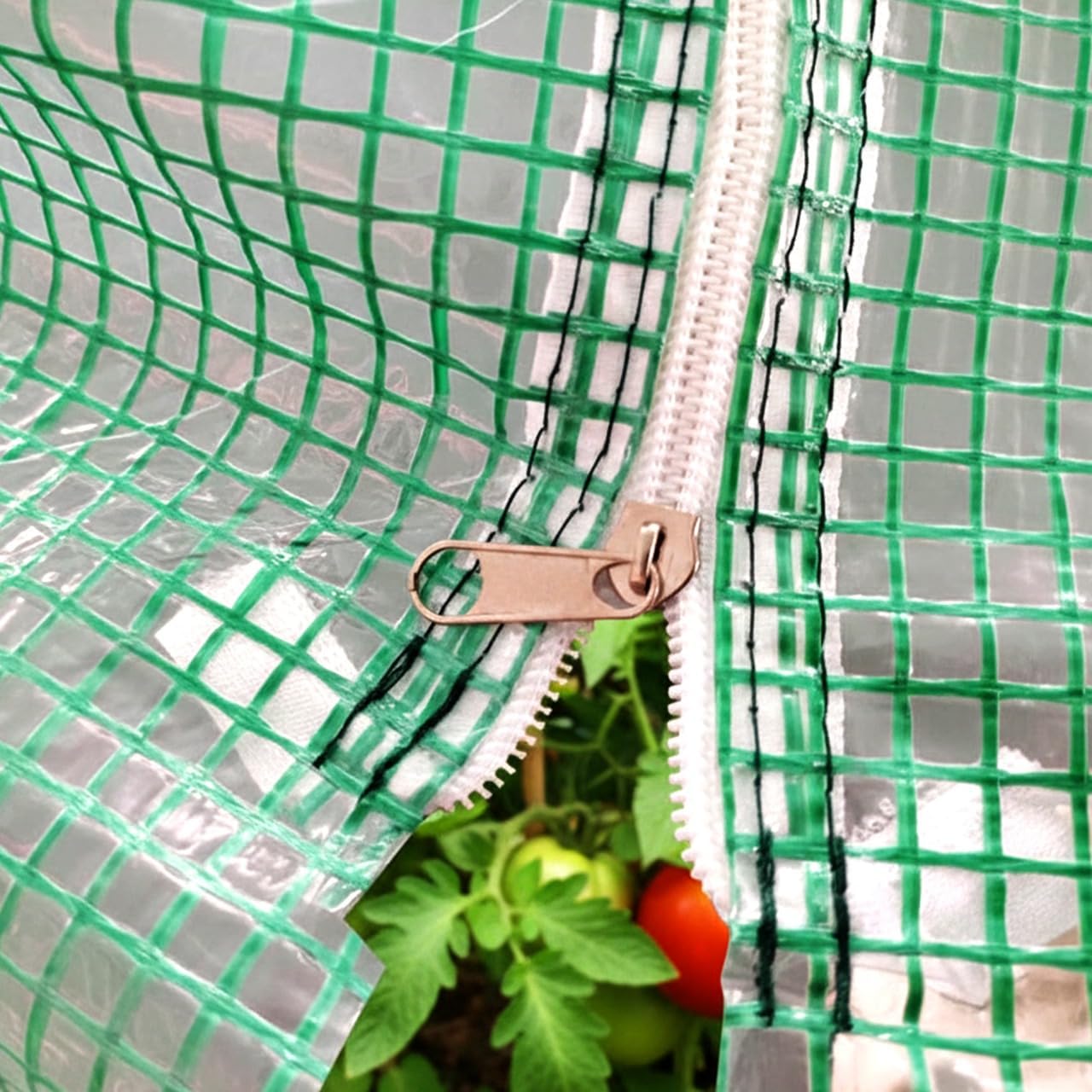 Close-up of the greenhouse door zipper, showing its robust construction