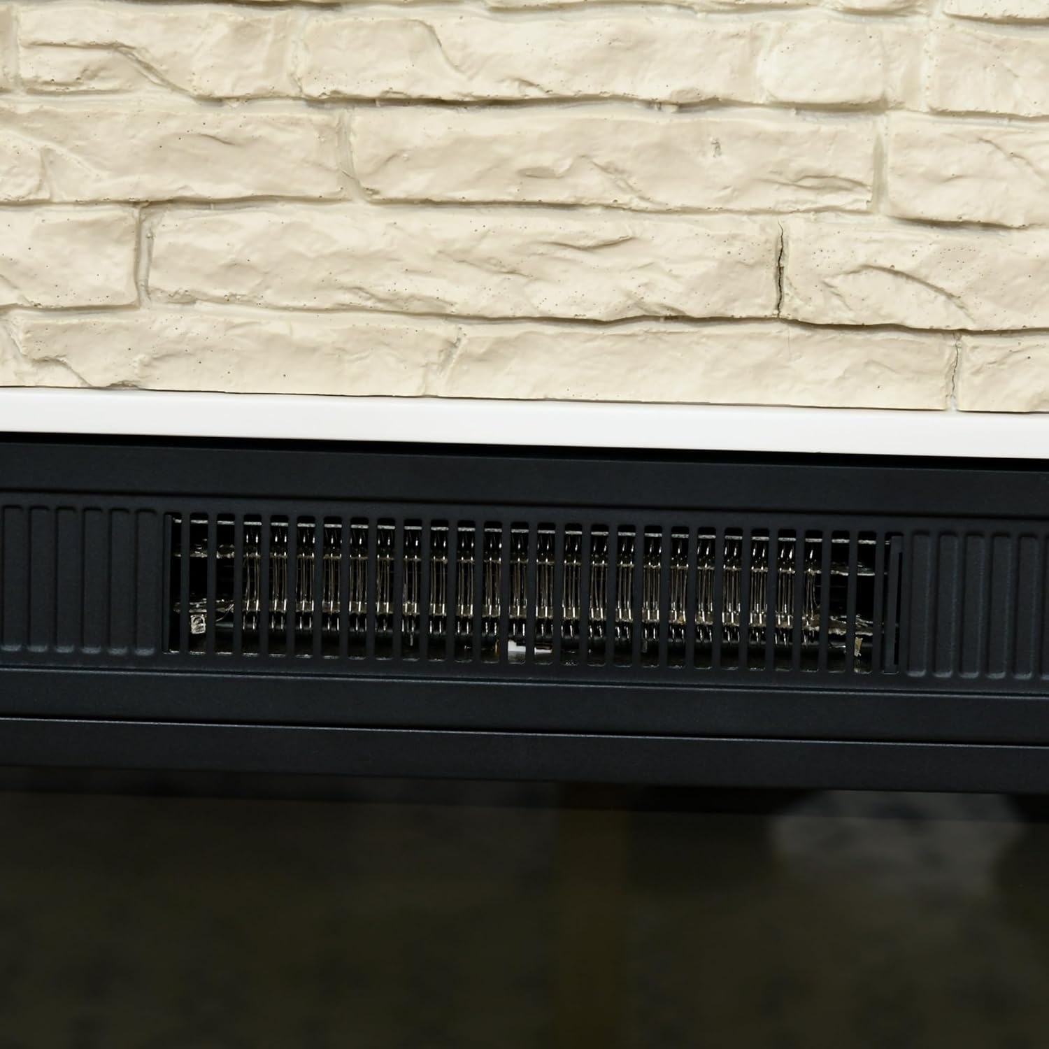 Close-up of the heater vent on the electric fireplace, showing the heating elements