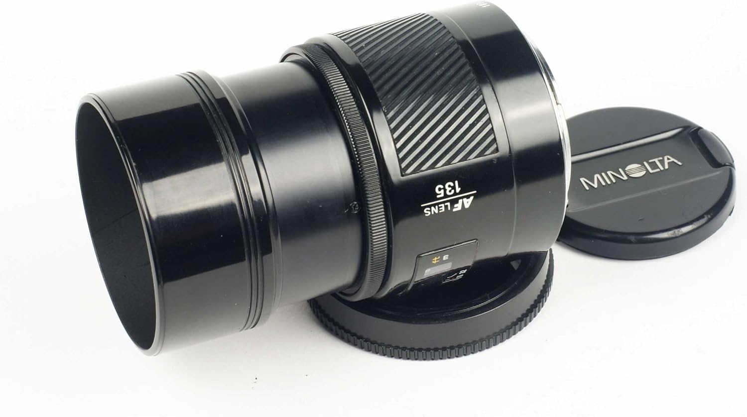 Minolta Maxxum 135mm f/2.8 lens with its built-in hood extended.
