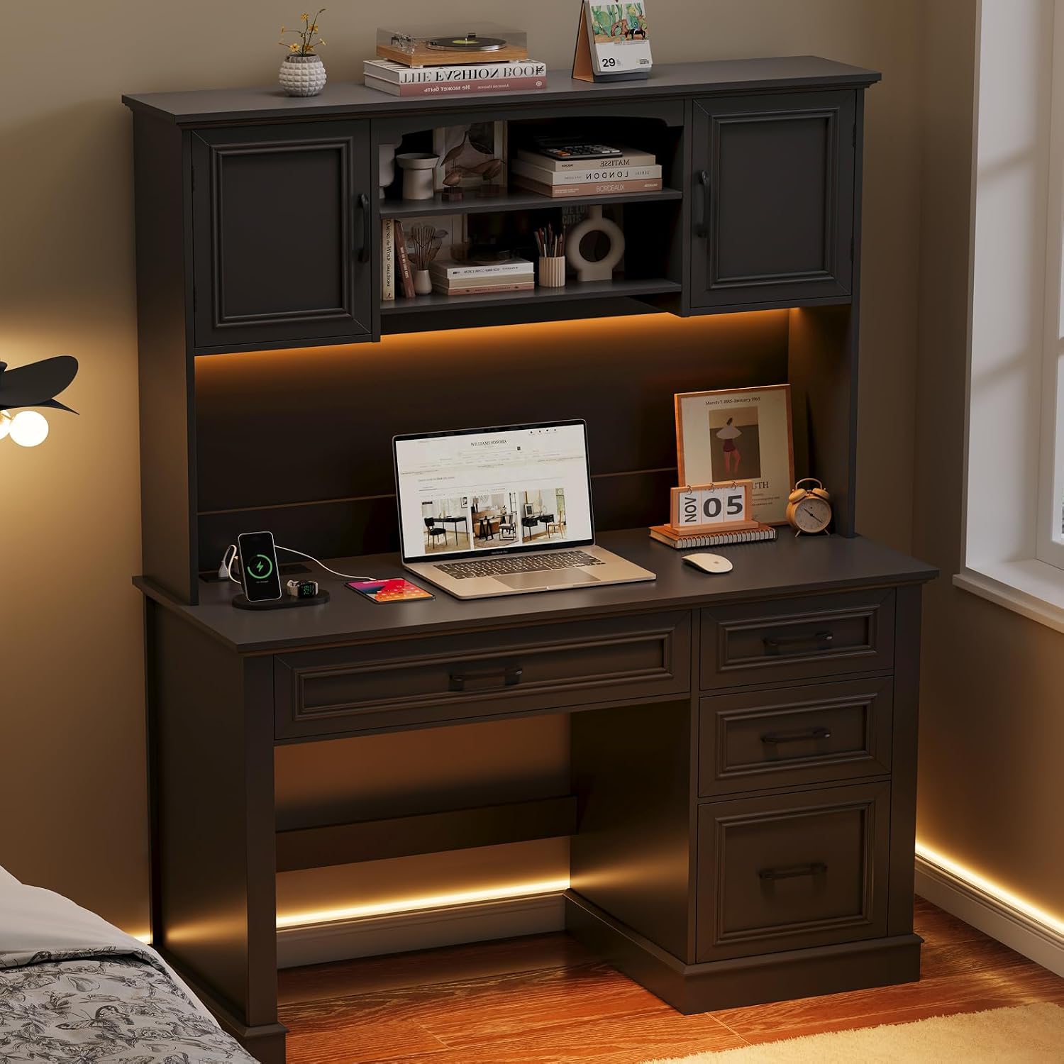 The desk illuminated by warm orange LED lights, creating a cozy ambiance in a room.