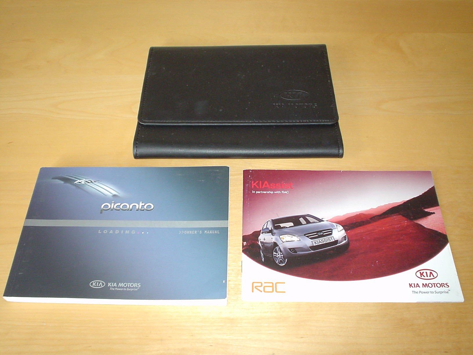 KIA PICANTO OWNERS MANUAL HANDBOOK c/w WALLET - OWNER'S HAND BOOK MANUAL Paperback – 1 Jan. 2005