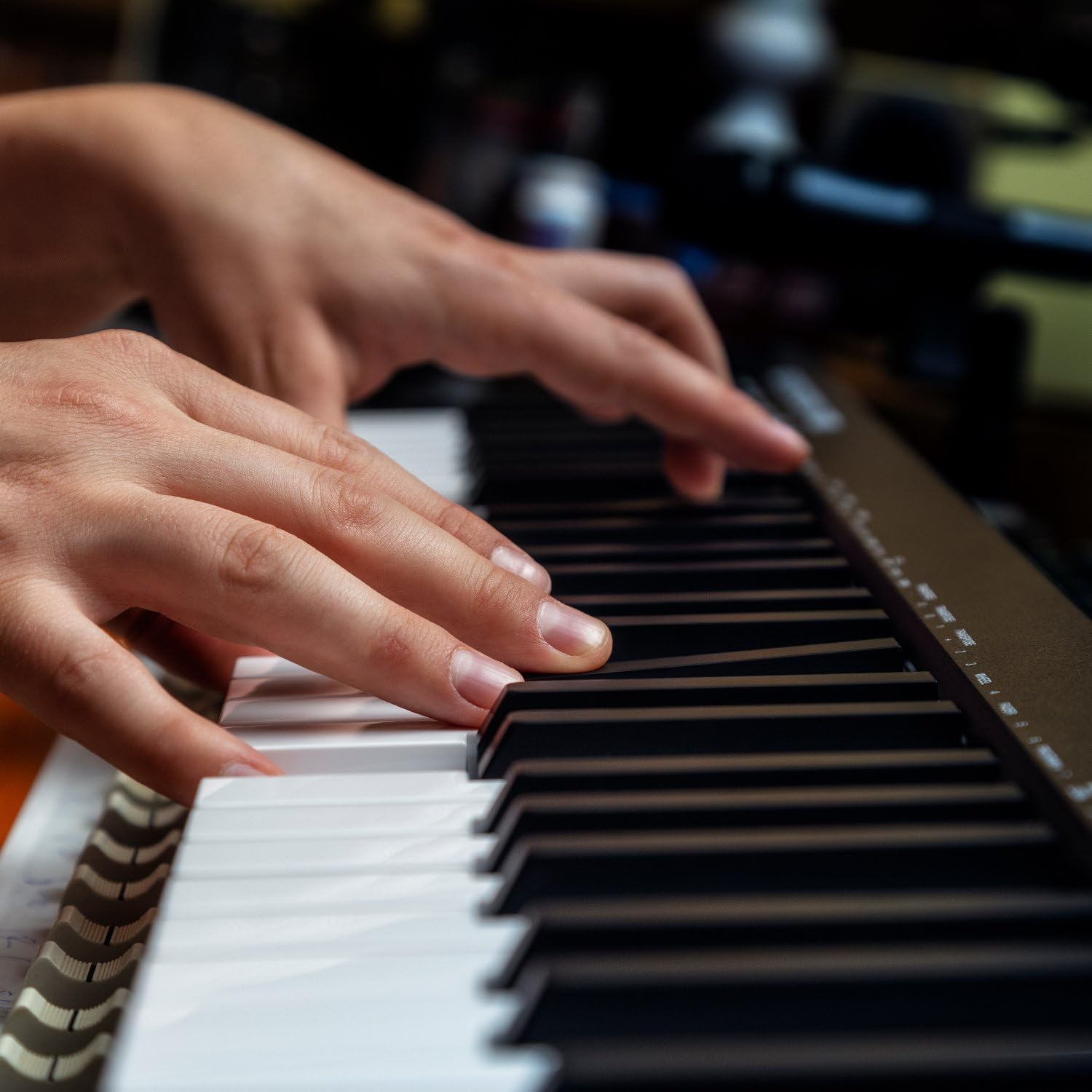 Close-up of hands playing M-AUDIO Keystation 61 MK3 keys