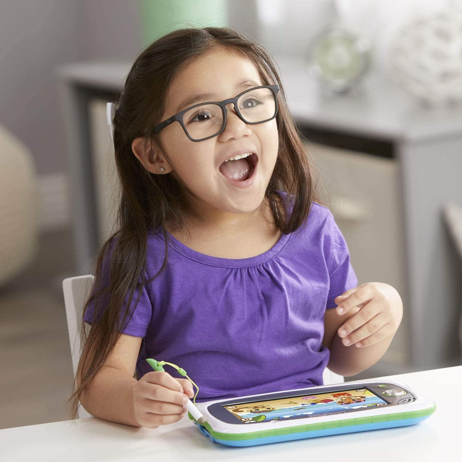 A child using the LeapFrog LeapPad Ultimate with the attached stylus, engaged in a learning activity.