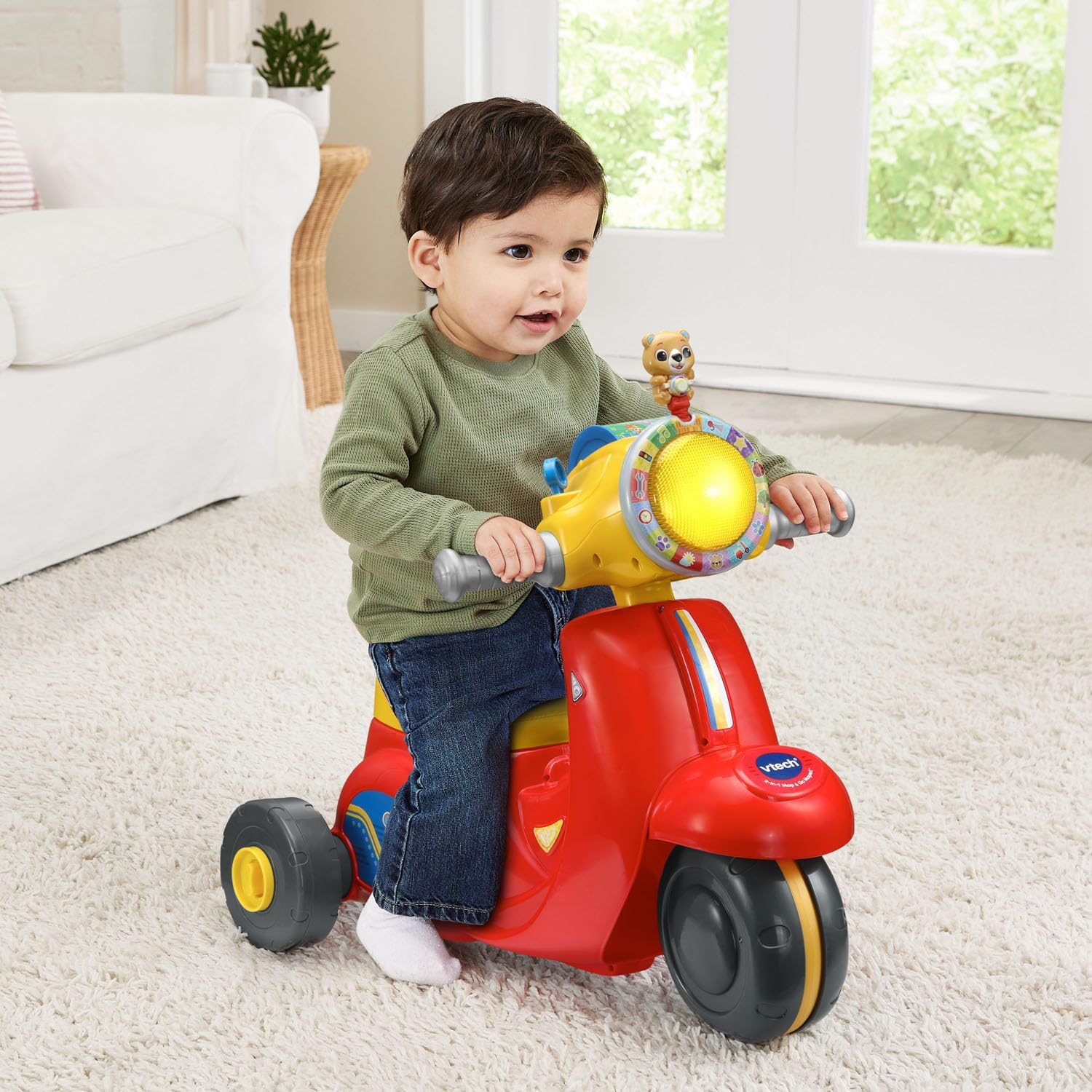A toddler riding the VTech 2-in-1 Map and Go Scooter in trike mode.