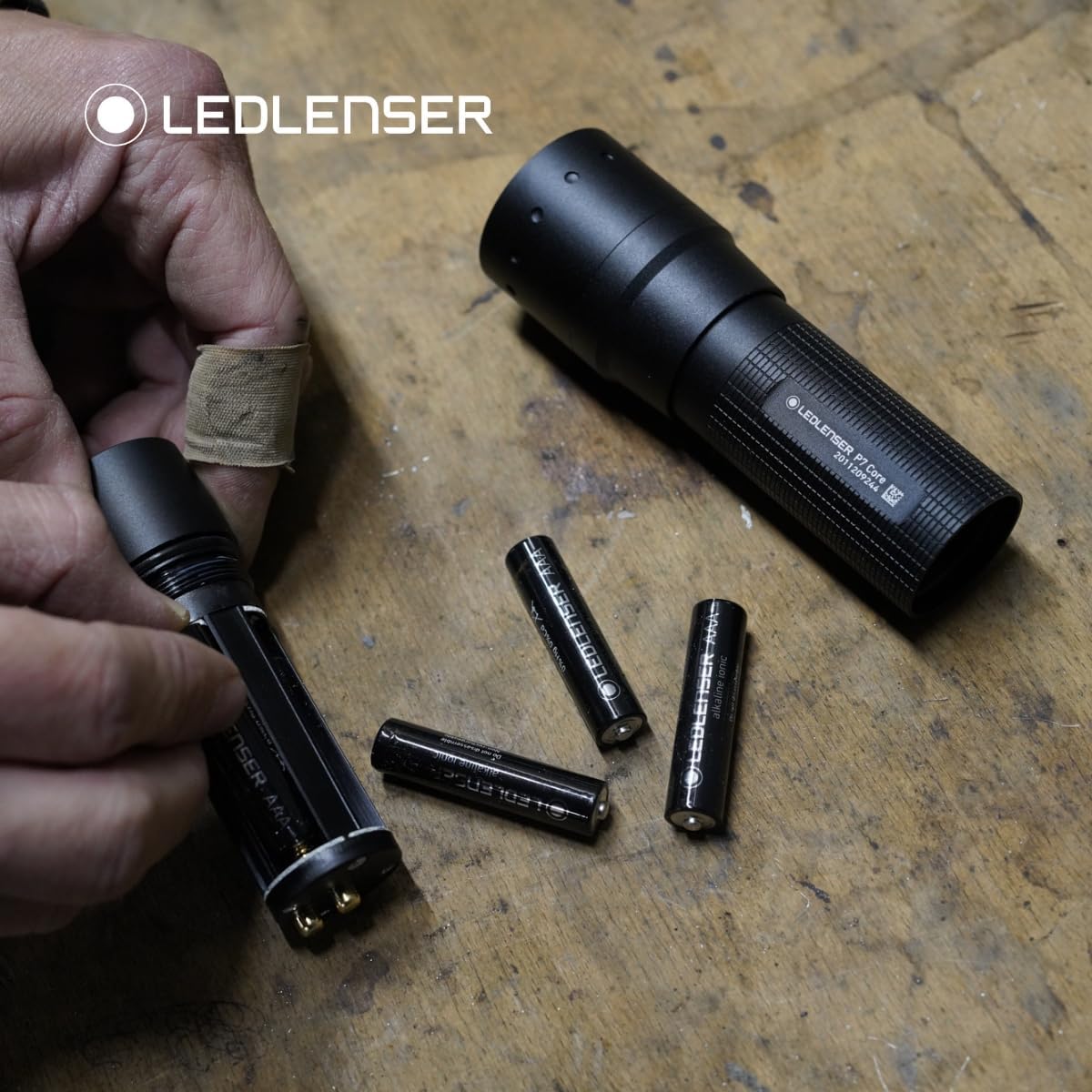 Person installing batteries into Ledlenser P7 CORE flashlight