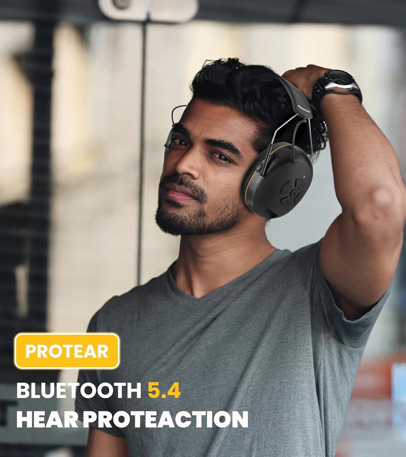 Man wearing PROTEAR E6850 earmuffs in a workshop setting