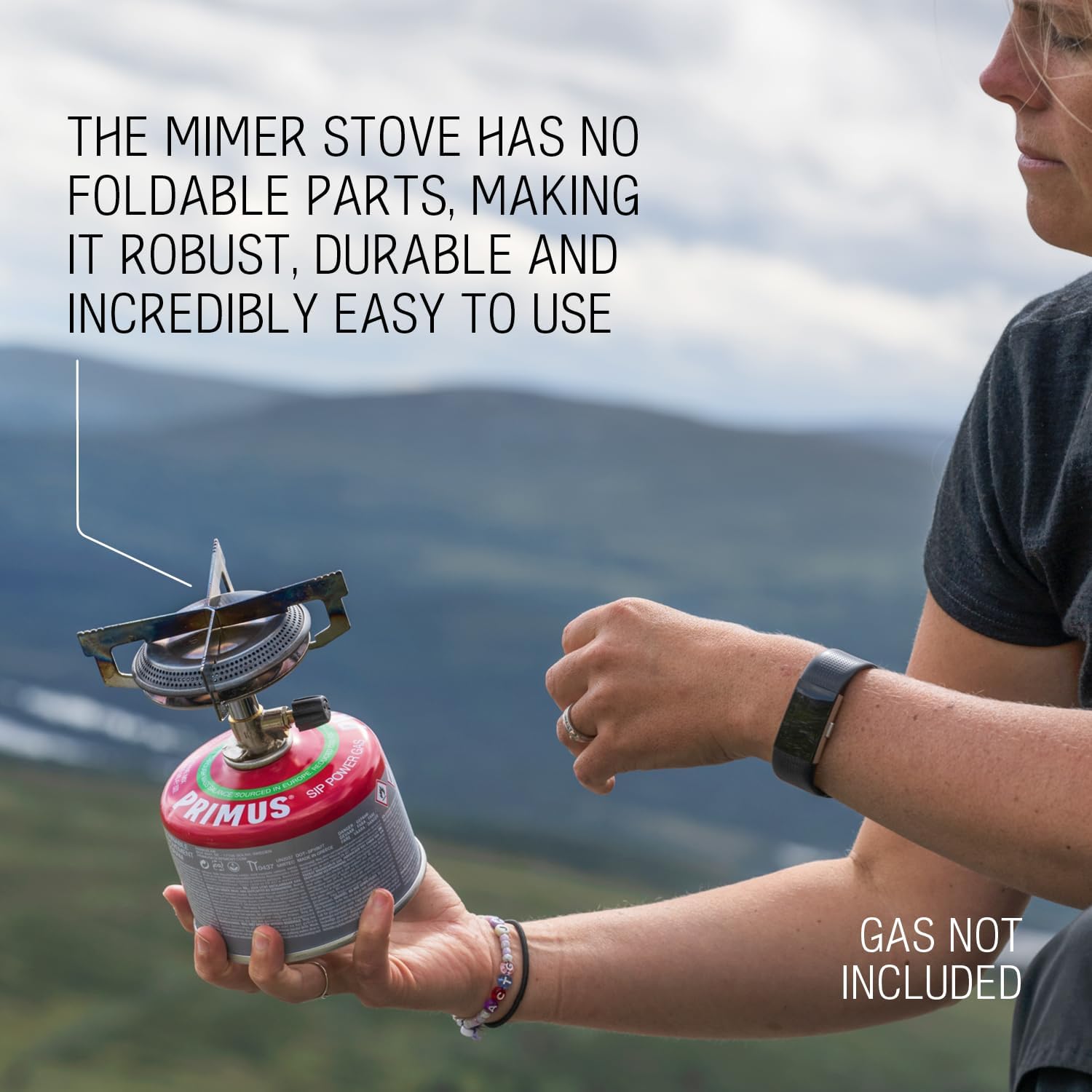 Person cooking with the Primus Mimer Gas Stove outdoors, showing a wide flame