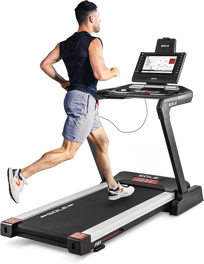 Sole F85 Folding Treadmill in Action - Premium Foldable Running Machine for Home Fitness Athletic man running on Sole Fitness F85 folding treadmill with digital console and tablet holder for home workouts