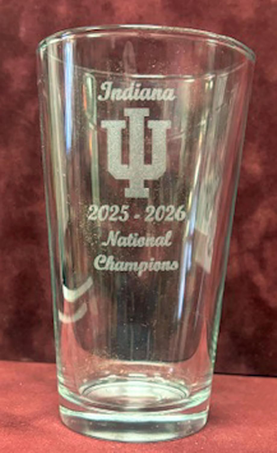 Set of 4 Indiana Hoosiers 2025-2026 Championship 16 oz pint glasses including 2026 National Champions, 2026 Peach Bowl Champions, 2026 Rose Bowl Champions, and 2025 Big 10 Champions