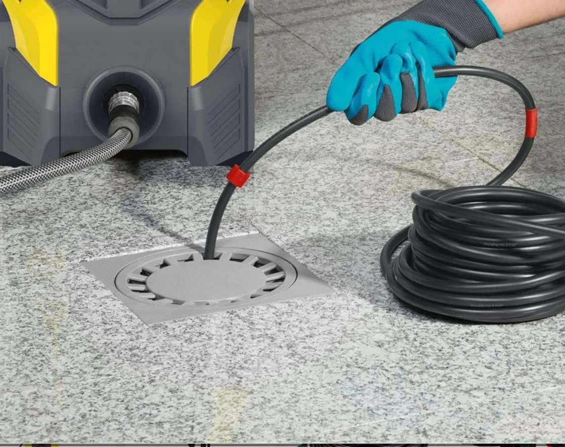 Person feeding the pipe unblocking hose into a floor drain.