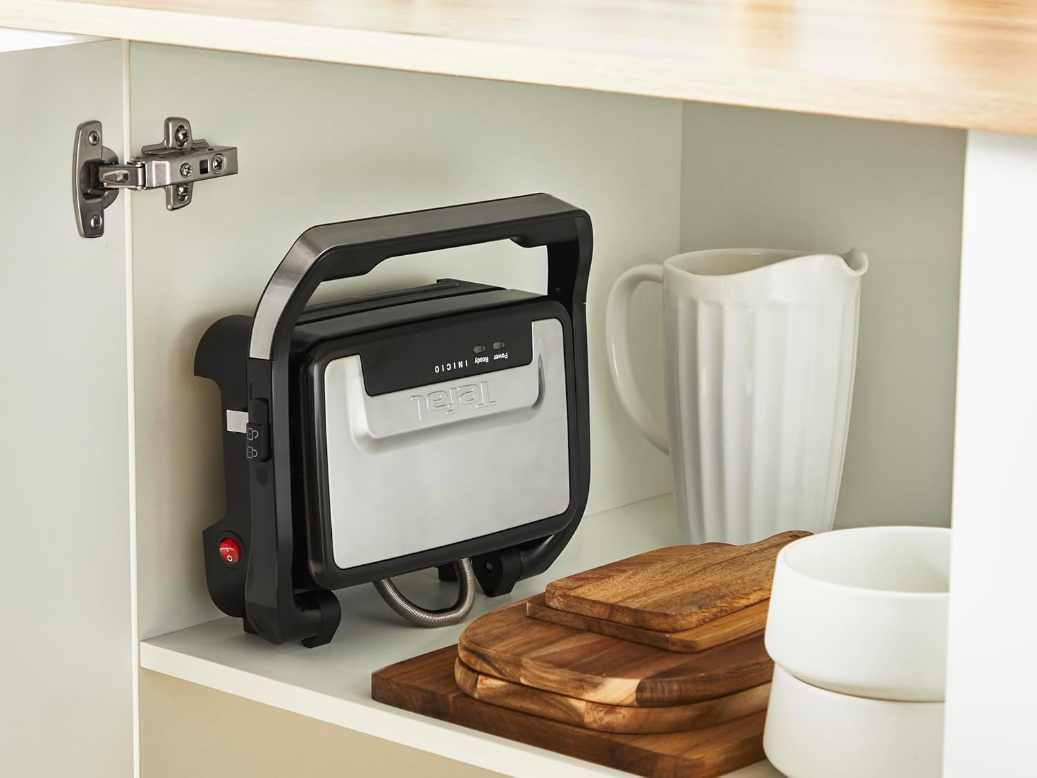 Tefal Inicio Compact grill stored vertically in a cabinet.