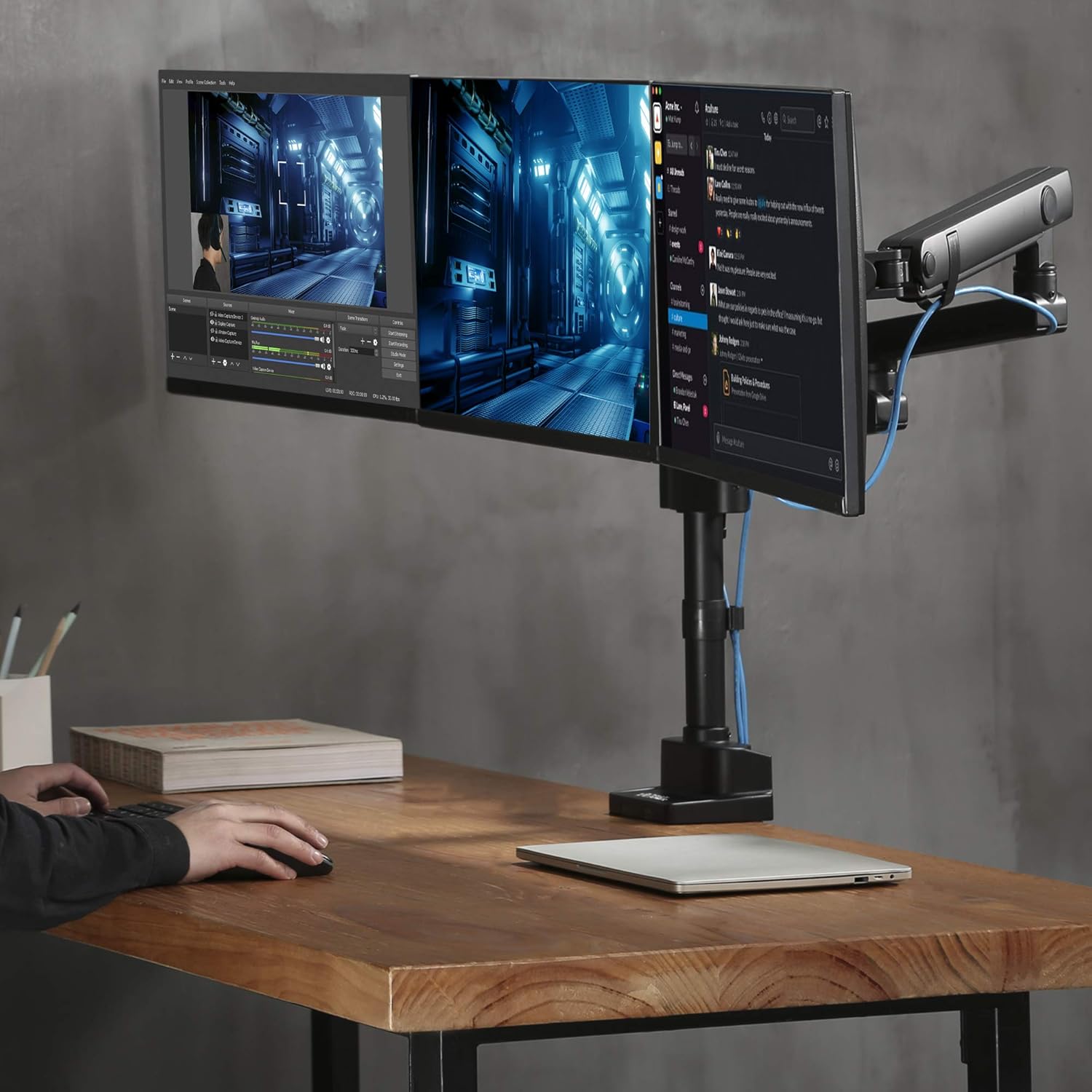 User working with two monitors on desk mount