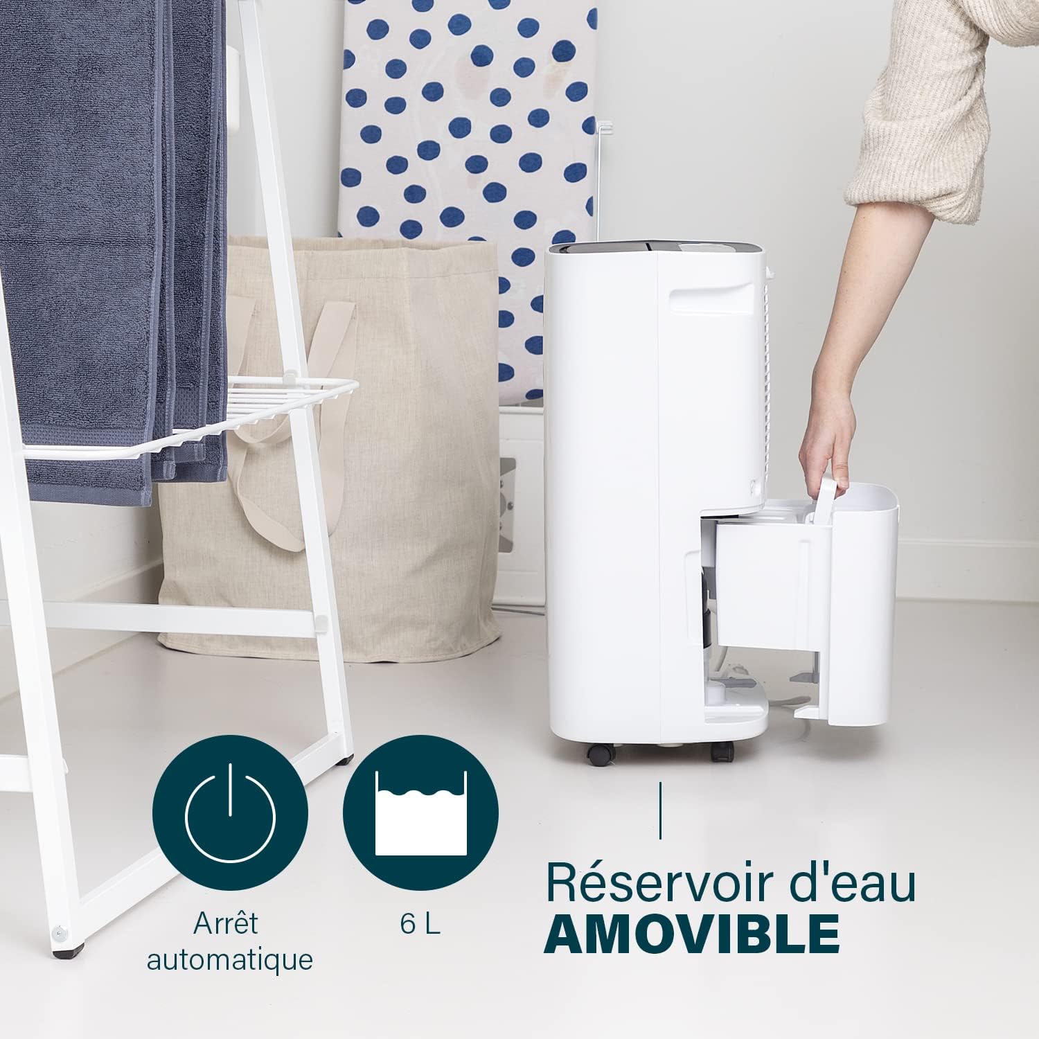 Person removing the water tank from the Princess 353130 Dehumidifier