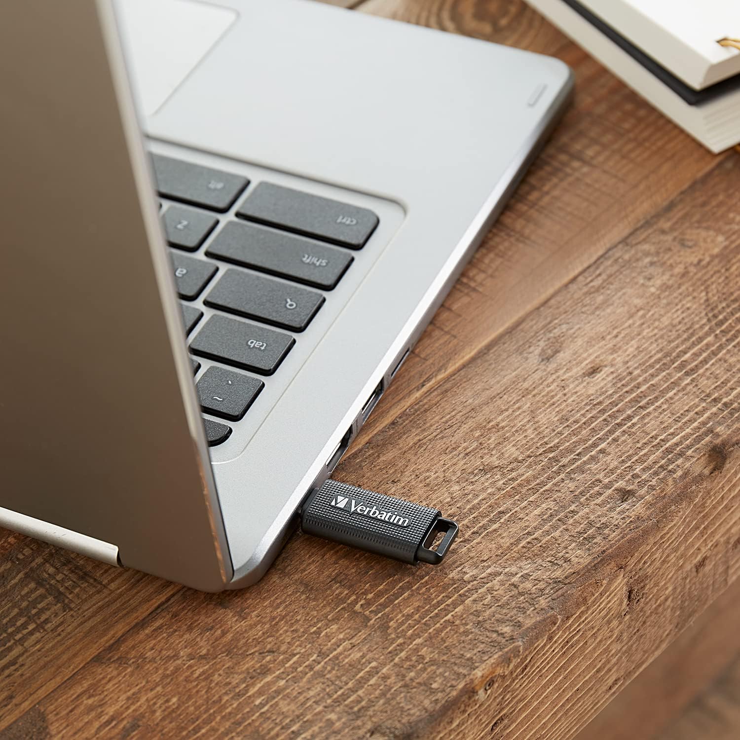 The Verbatim USB-C Flash Drive inserted into the USB-C port of a laptop, showing a typical connection scenario.