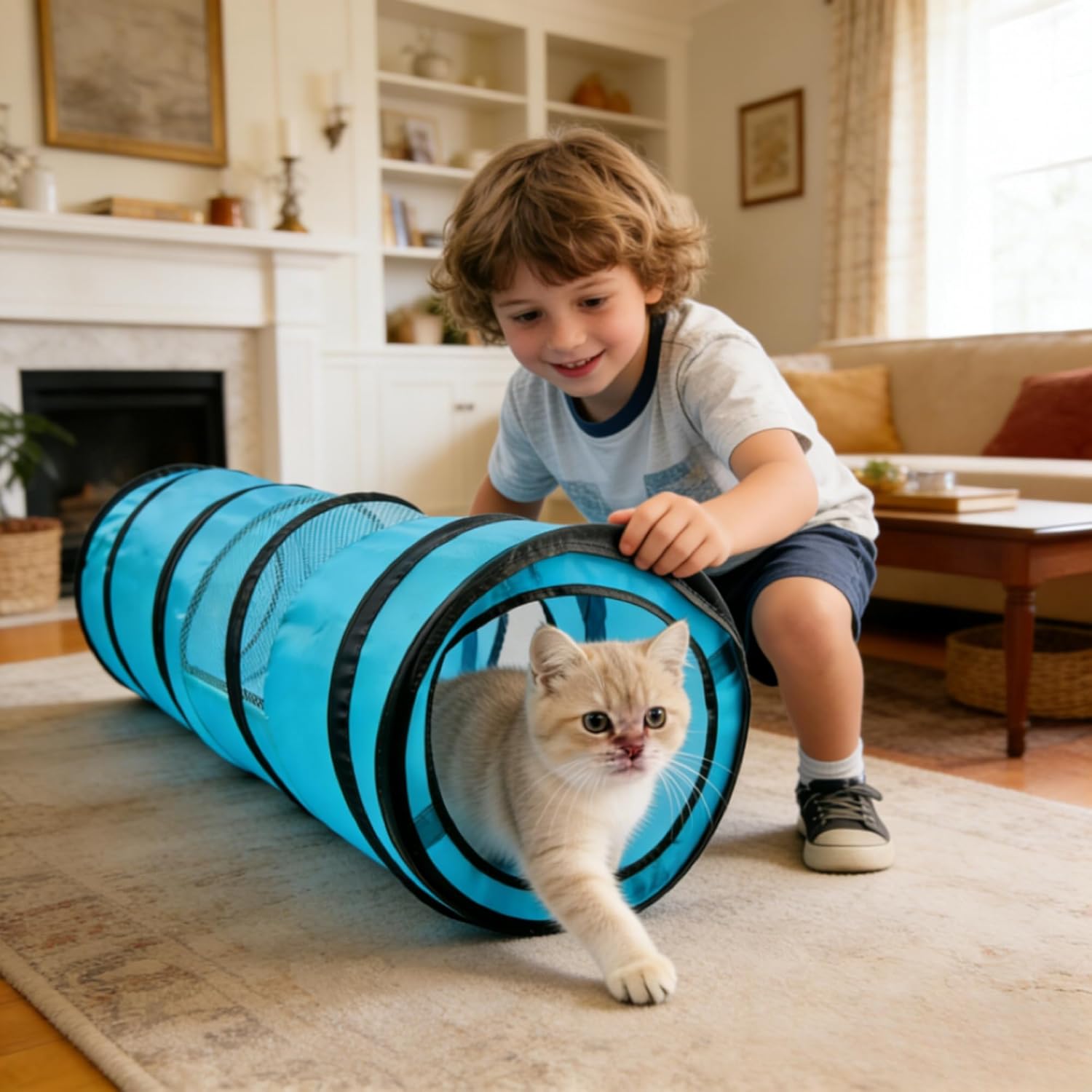 A young boy playing with a cat in the blue PAWISE Collapsible Cat Tunnel, demonstrating interactive use.