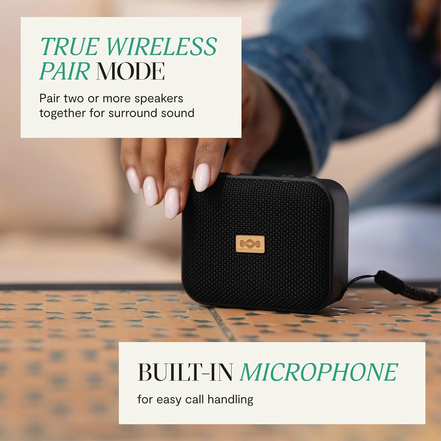 Hand holding the Jammin' speaker, with text overlays indicating True Wireless Pair Mode and Built-in Microphone.
