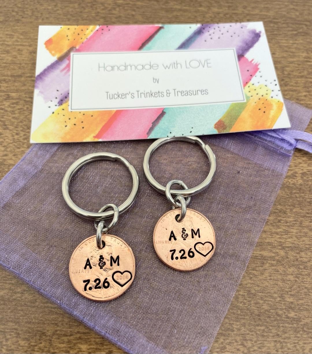 A Pair of Personalized Lucky Copper Penny Key Chains with Date, Initials and Heart Around Year