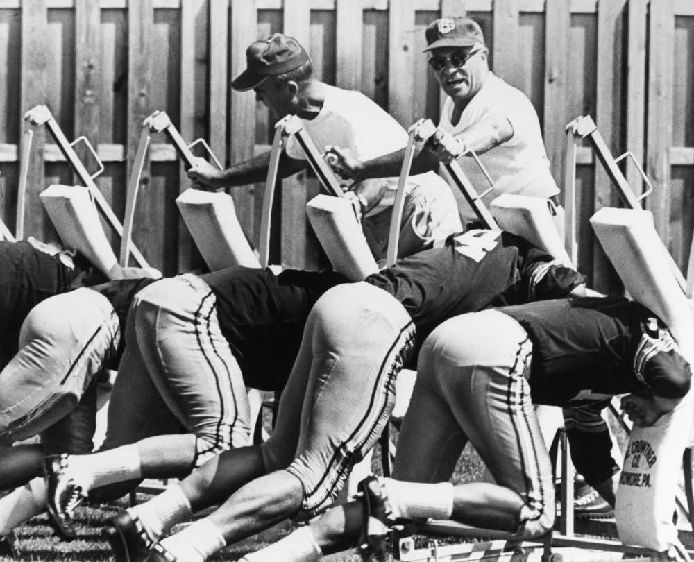 Vince Lombardi (1913-1970) Namerican Football Coach As Head Coach Of The Green Bay Packers Urging His Players On As They Practice On A Blocking Sled At The TeamS Training Camp In Green Bay Wisconsin 1