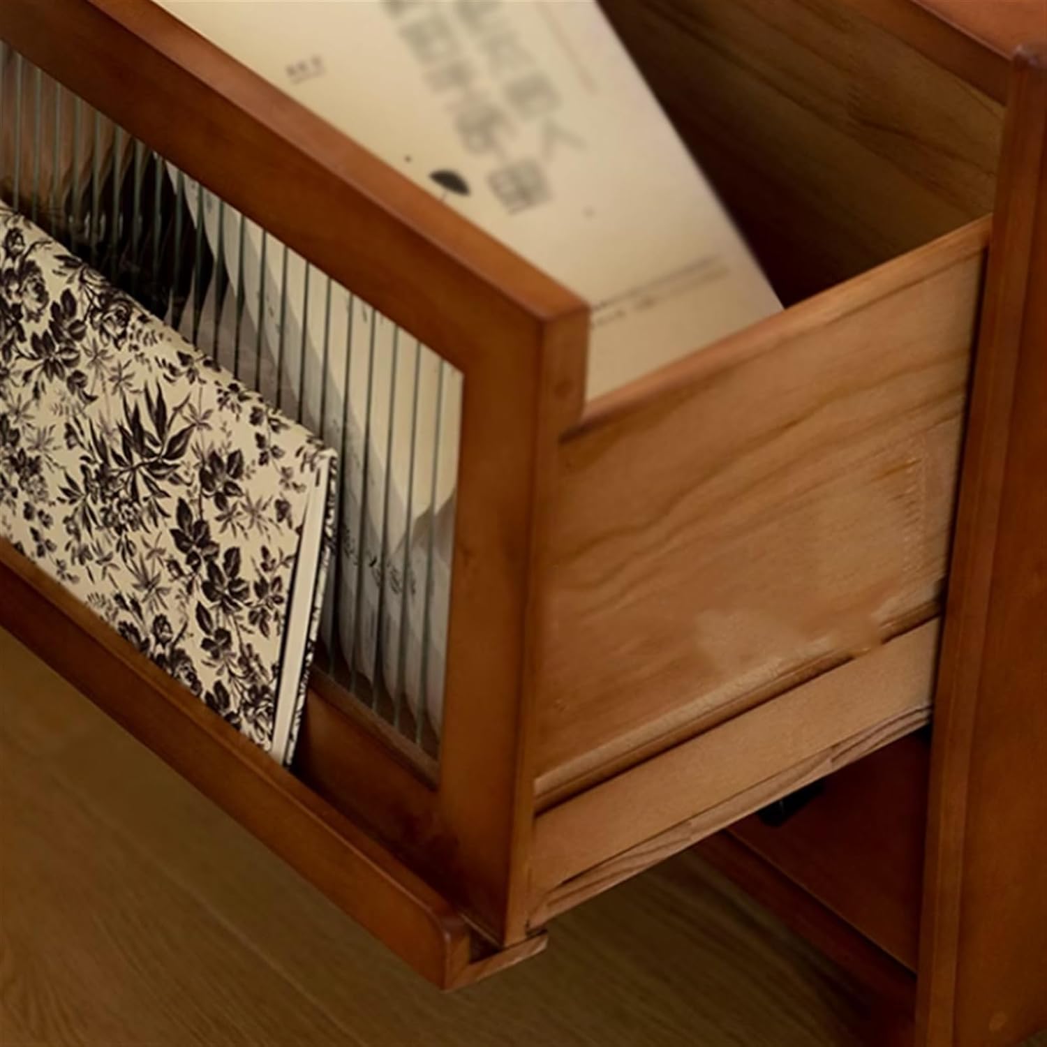 ഉള്ളിൽ view of the nightstand's glass door compartment with items stored
