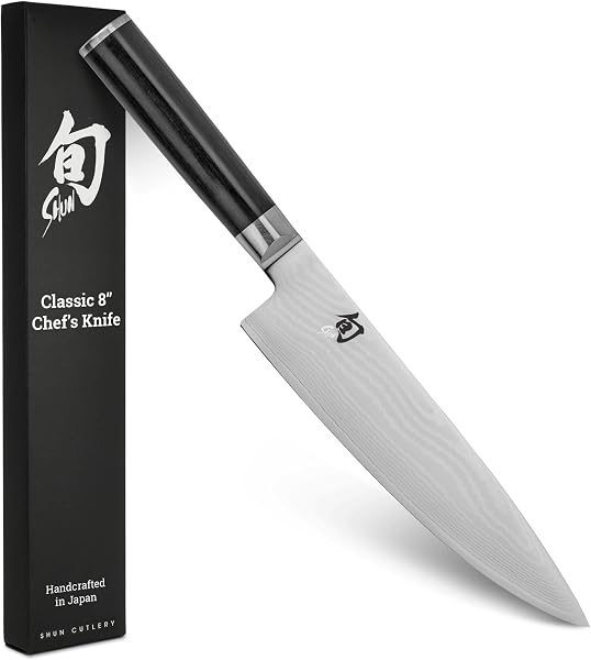 Close-up view of the Shun Classic 8" Chef's Knife blade showing its layered Damascus pattern.