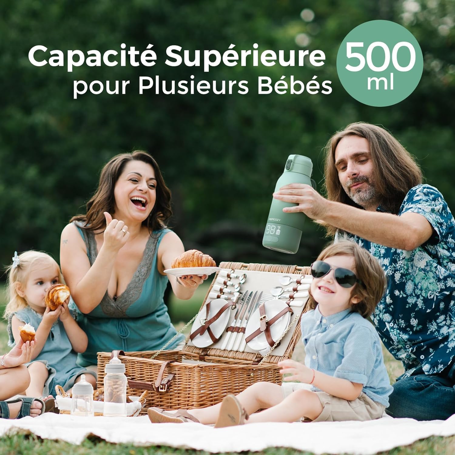 A family enjoying a picnic with the Momcozy bottle warmer, emphasizing its 500ml capacity for multiple babies.
