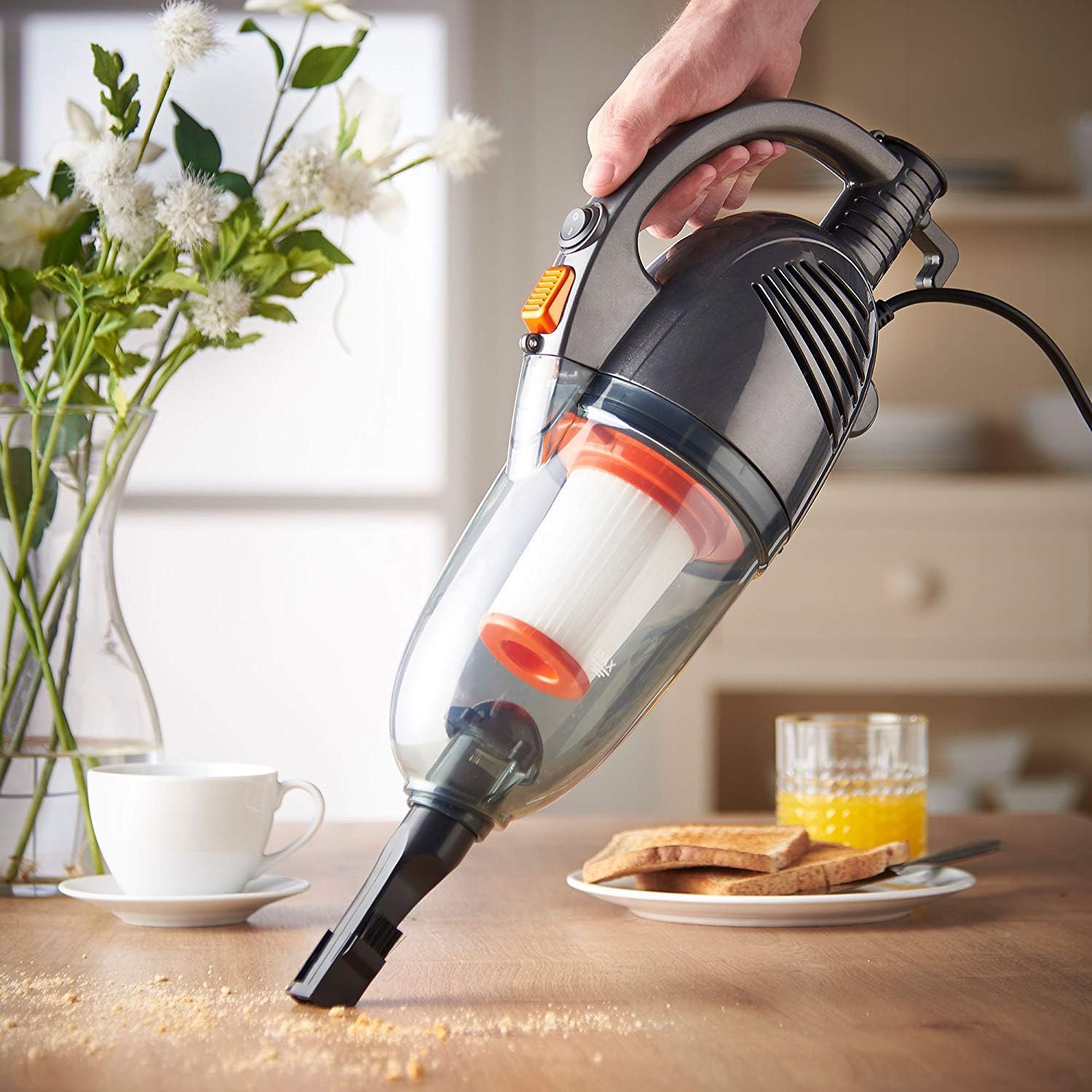 Handheld VonHaus Stick Vacuum Cleaner with crevice tool cleaning a table surface.
