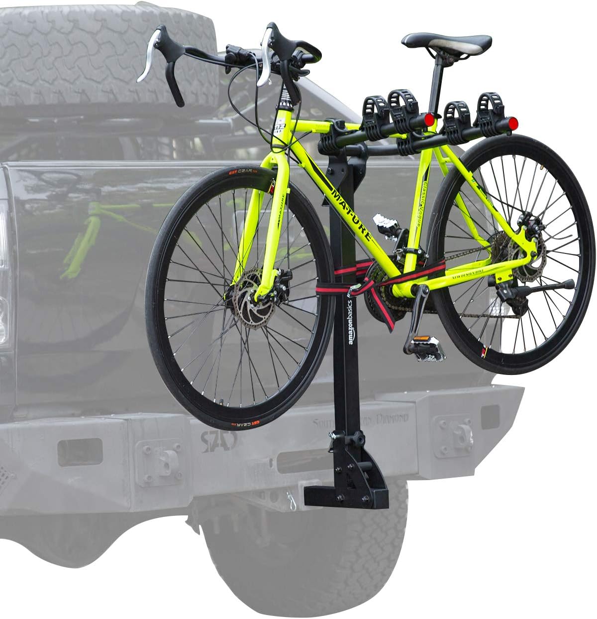 A bright green bicycle loaded onto the Amazon Basics hitch rack, attached to the rear of a black pickup truck.