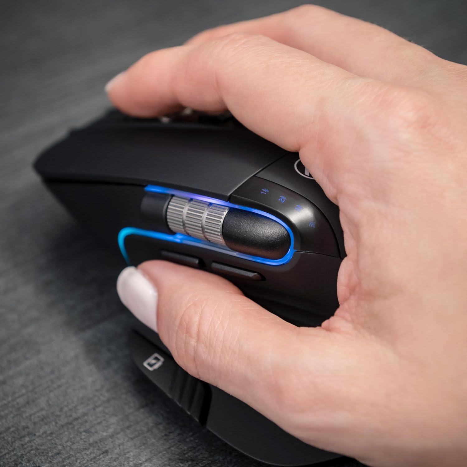 Hand using TELLUR Shade Wireless Mouse, showing thumb resting near Windows Home button