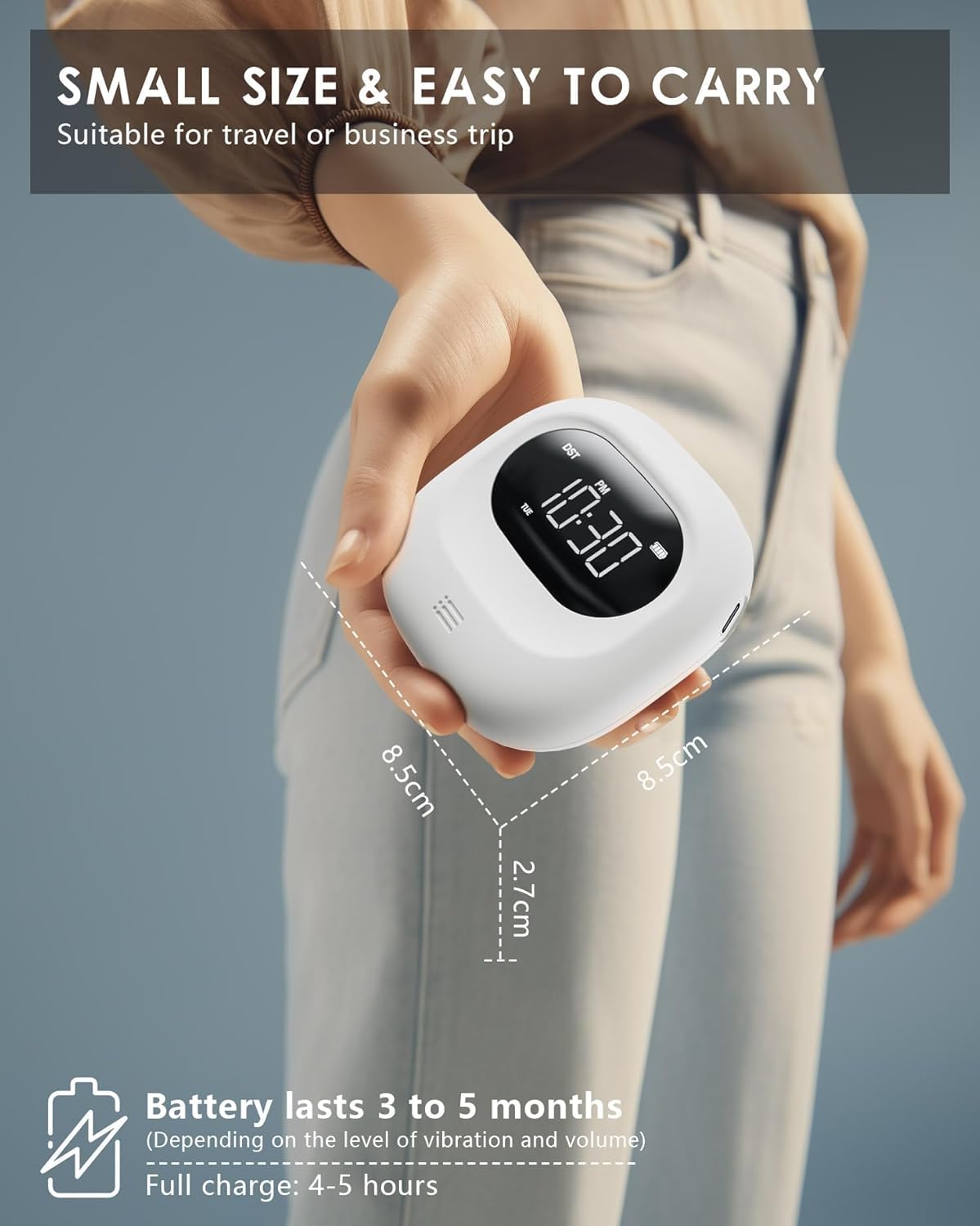 Hand holding the compact ROCAM Vibrating Alarm Clock, illustrating its small size (8.5cm x 8.5cm x 2.7cm) and long battery life of 3 to 5 months.