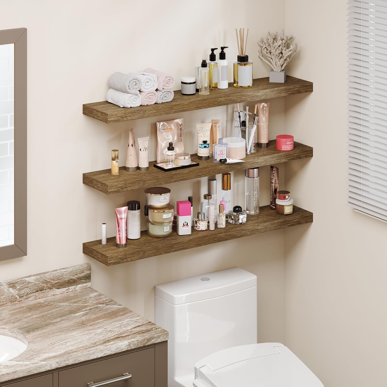 Three floating shelves installed above a toilet in a bathroom, holding various beauty products and towels.